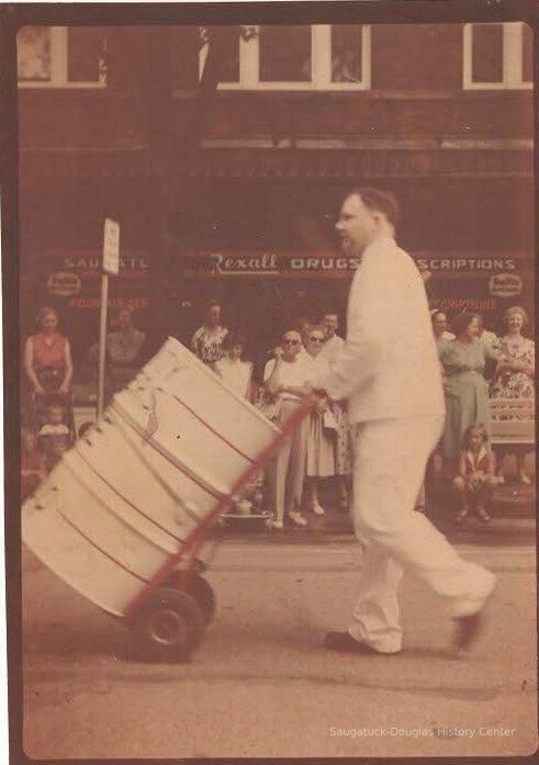          man with metal drum in parade
   