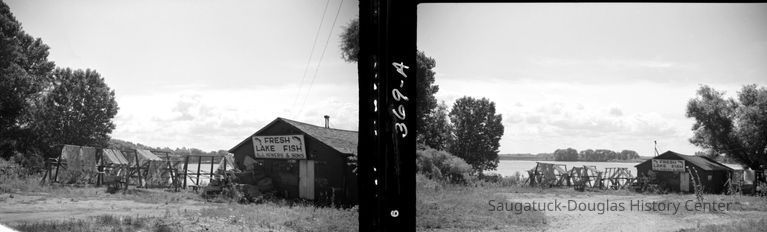 # 369 This is the Sewers fish house east of the Blue Star Highway and north of the Blue Star bridge. It burned in the 1970s. In the background is a distinctive row of trees south of the river where there used to be a quonset shaped boathouse.
Source: SDHS newsletter pg 238