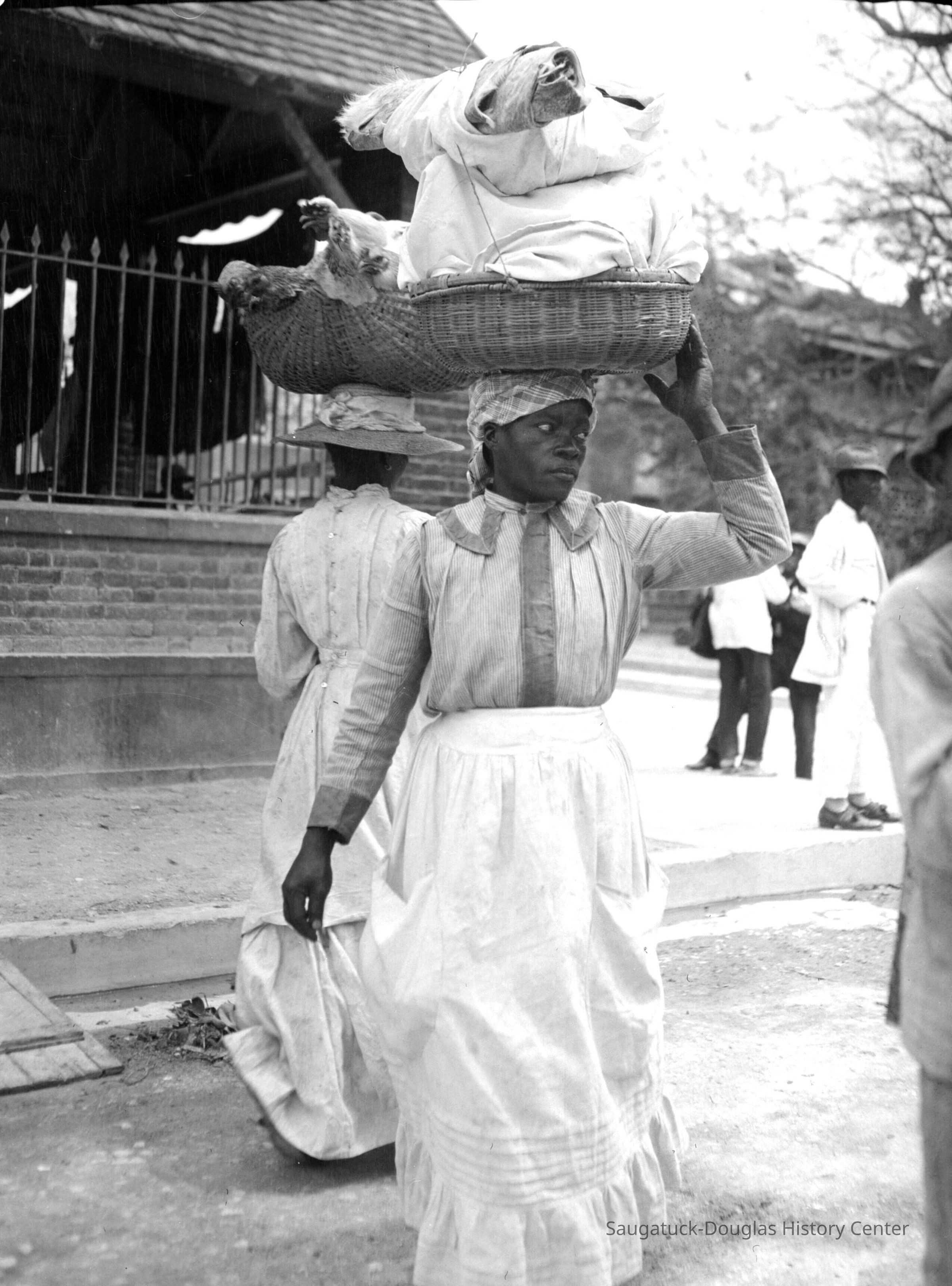 Woman with basket of goods balanced on her head