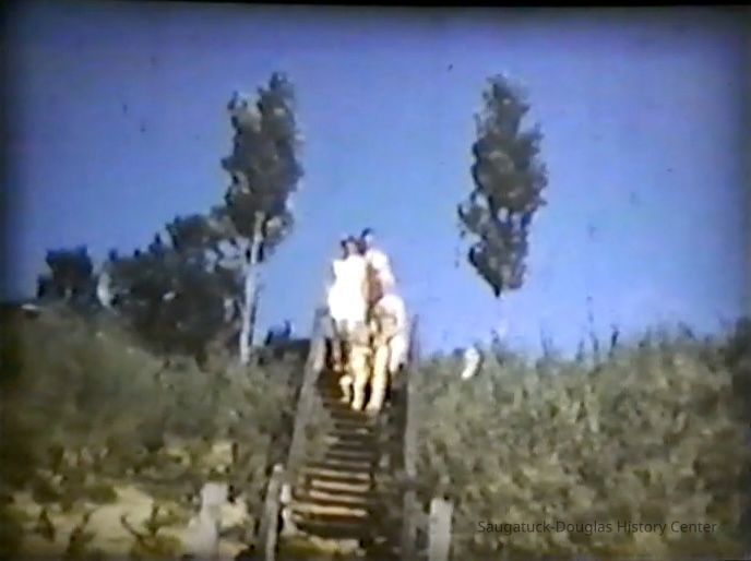          Family desending the stairs for a day of fun at Oval Beach
   