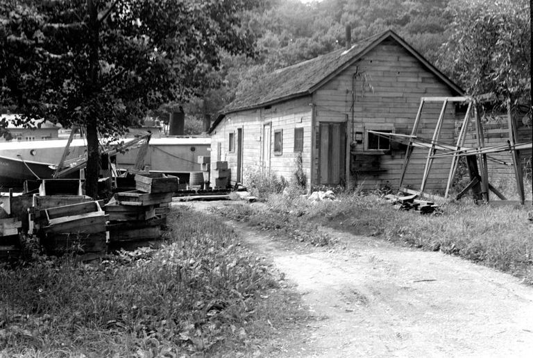 This image was featured as History Mystery #10 with the solution: The Village pumphouse, the Gotham fish tug and the Sewers fish house as seen from Water Street ca 1943.