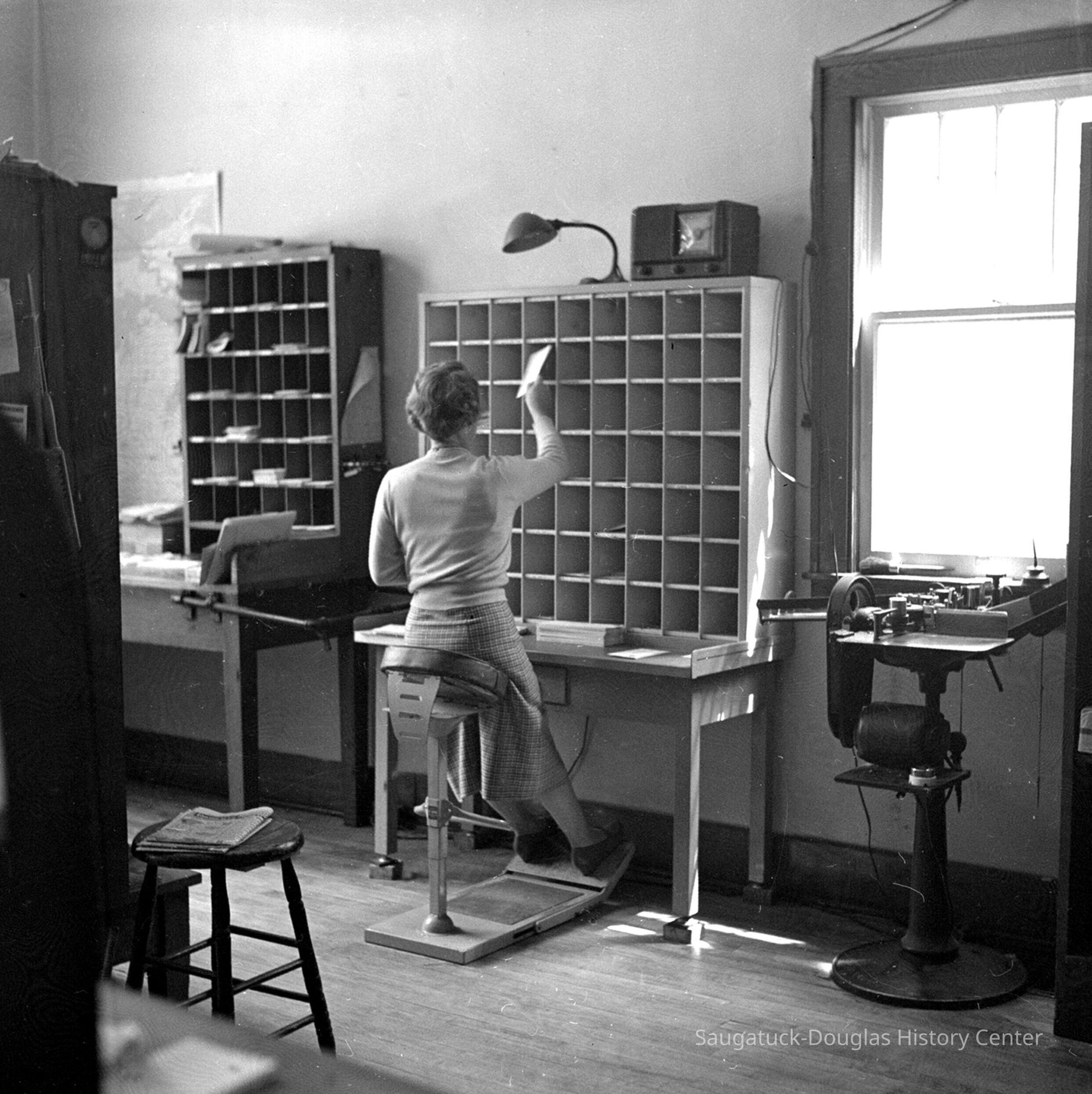          Betty Martin sorting mail at post office when it was at 238 Butler Street.
   