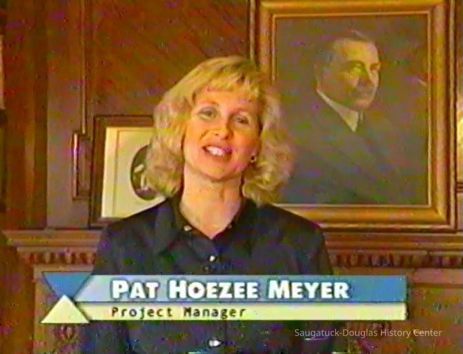          Pat Hoezee Meyer in front of a portrait of Dorr Felt
   