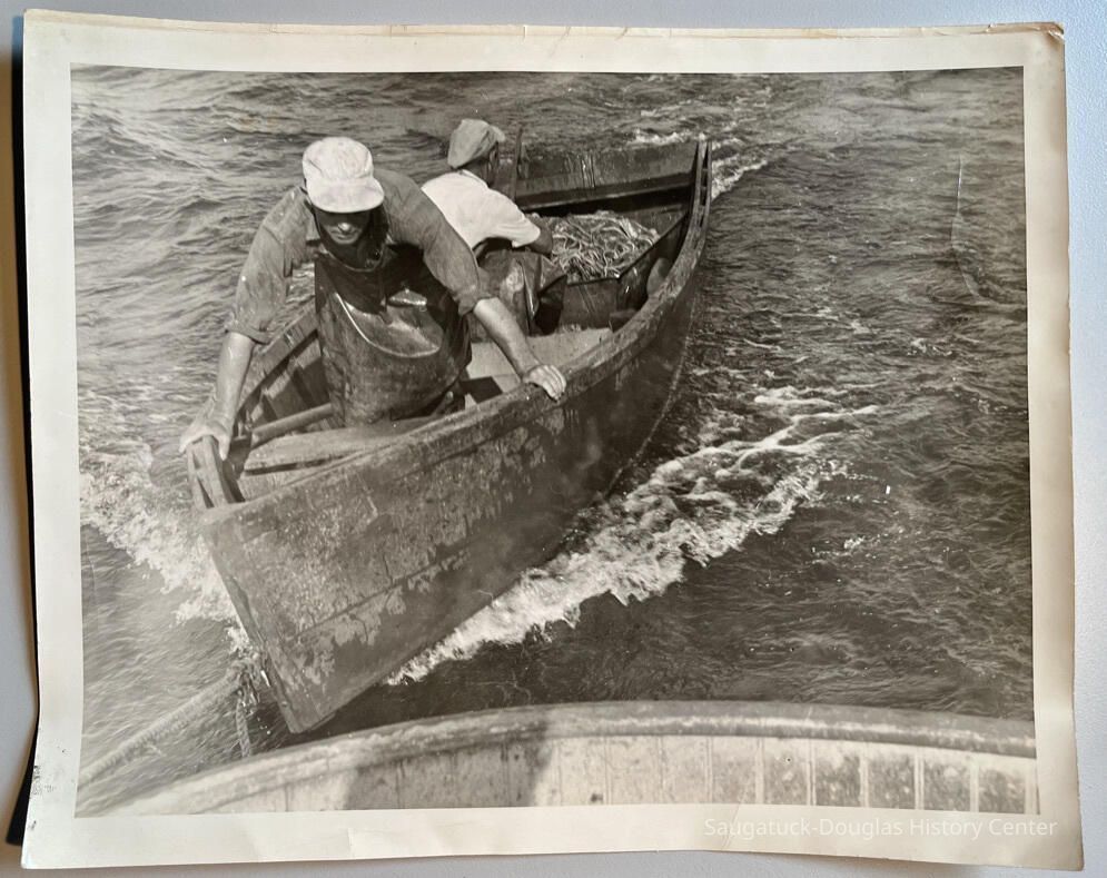 1; John Diepenhorst and an unidentified man in a dingy towed behind a fishing tug.
