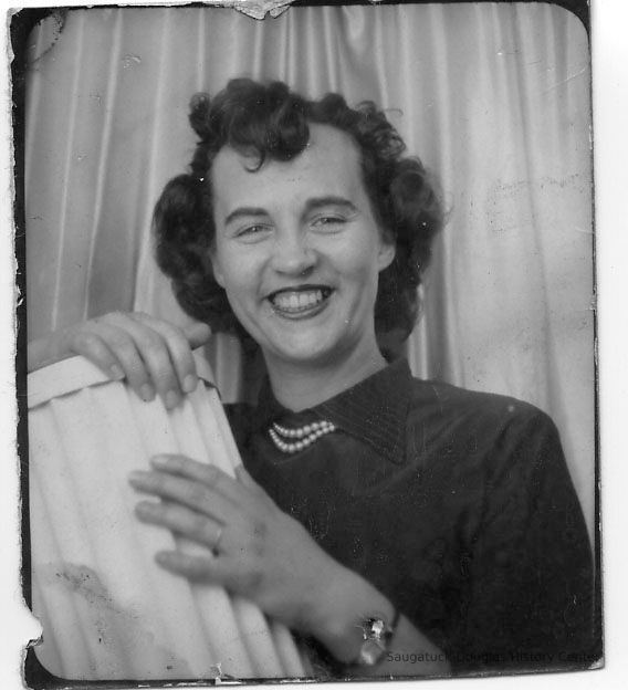          89-1-106_Mary_Heath.jpg 70KB; Mary Heath - Young woman with dark wavy hair, dark shirt and twin-strand pearl necklace is holding a section of a fluted column. May be graduation photo, circa 1950s
   