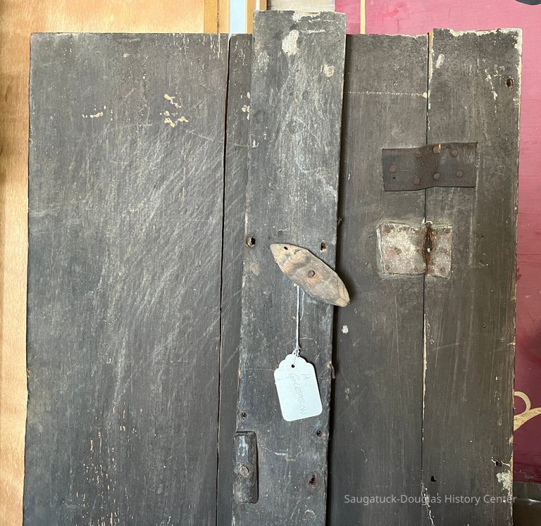          Door is shown behind latch plate. White tag marked 