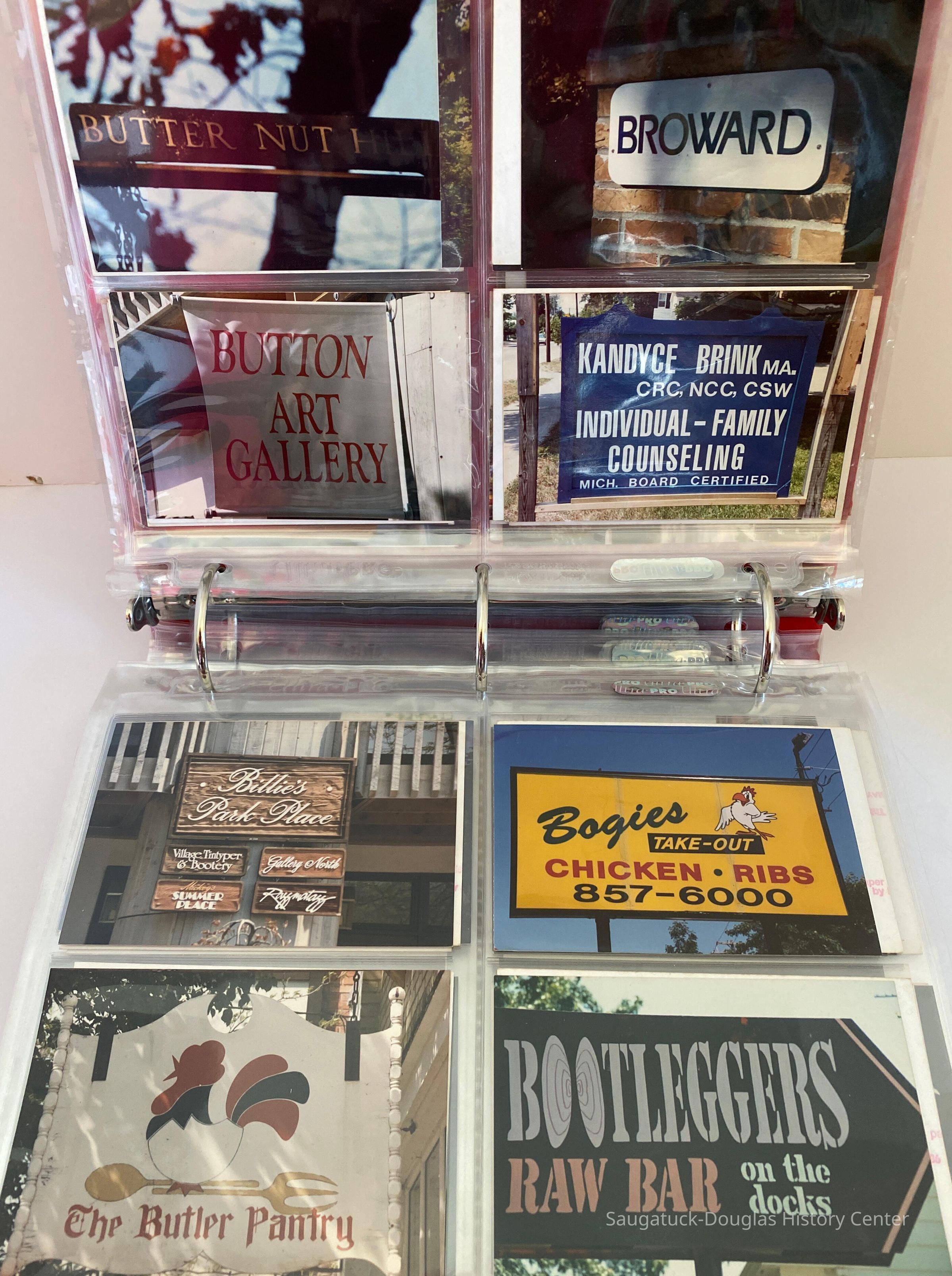          A 3 ring binder containing photos of the business signs of Saugatuck over the years
   