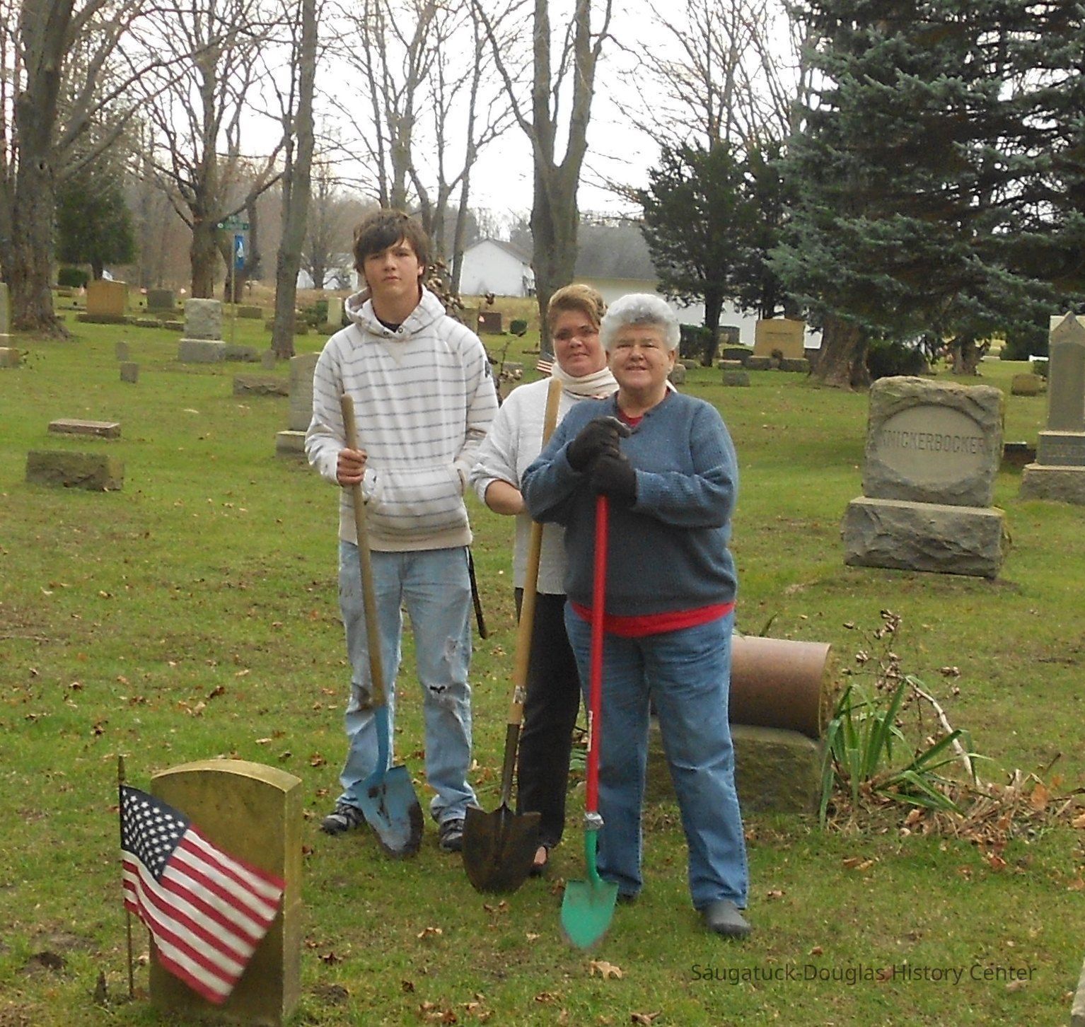          D4-2011-2-cr.jpg 559KB; DDDD 2010
For a second year, a hardy crew braved windy weather to plant 36 dozen daffodils at graves in Riverside, Douglas and Taylor cemeteries. Plots were selected, in the most part, to address folks with no descendants or no local ones remaining. Thanks to HUNTREE for providing a 12 dozen of the bulbs used. Volunteers included Joy Muhlenbeck, Doreen and Nathan Tubergen, Charlie Hancock and Chris Yoder.  A brief sketch of those recognized appears below:
Riverside
1. Rev Ezra Scovel (1794-1874) -Graduate of Middlebury College, VT. Pastored in Mexico, NY and elsewhere. 