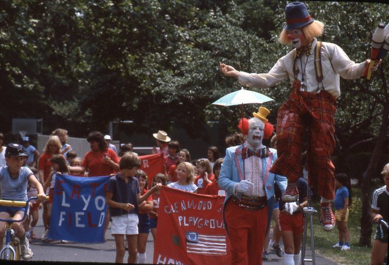          Alison Lightner holding the Glenwood Playground flag (center).
   