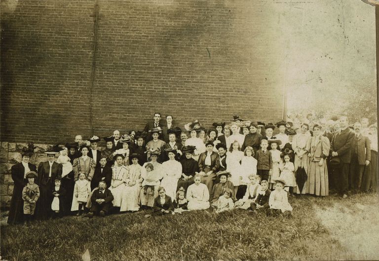          Group photograph of people in front of a brick building, c. 1905 picture number 1
   