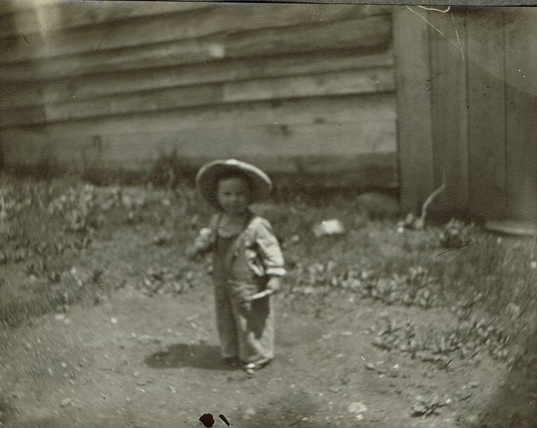         Marshall-Schmidt Album: Young Child in a Yard Wearing a Straw Hat picture number 1
   