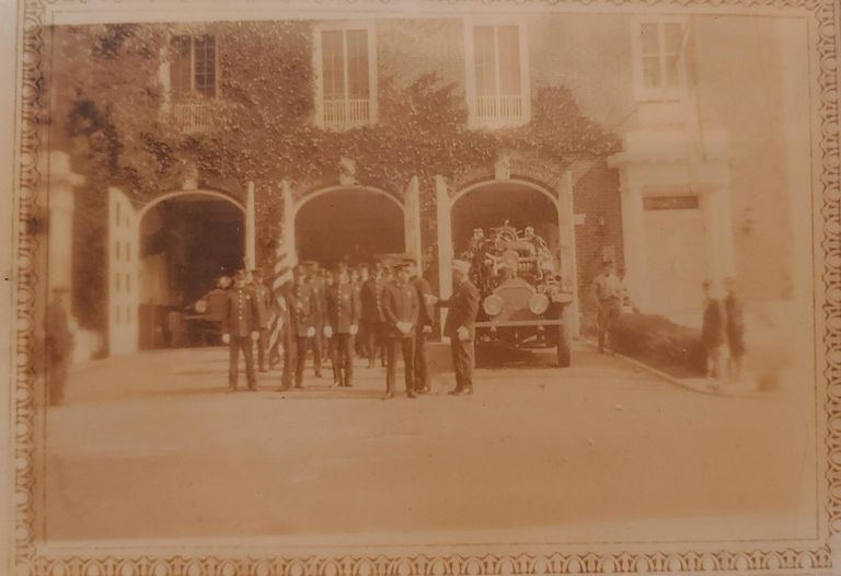          Fire Department: Photograph of many firefighters standing beside a firetruck outside the station picture number 1
   