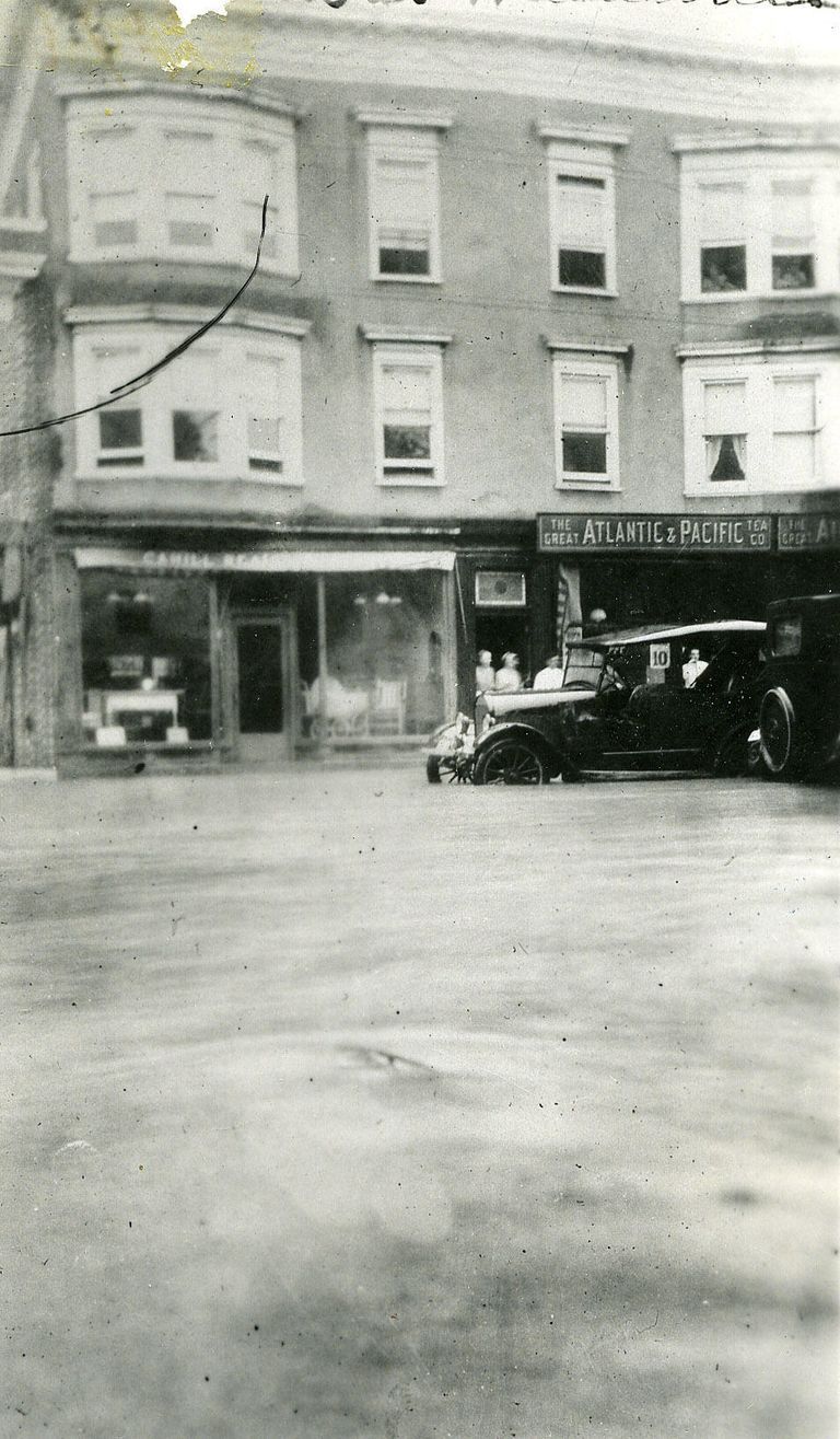          Looking at the A&P grocery store at 333 Millburn Avenue with 2 cars navigating the flooded avenue; Image Id # 395
   