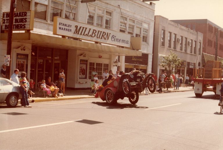          Antique Car popping a wheelie in front of the Millburn Cinema.
   