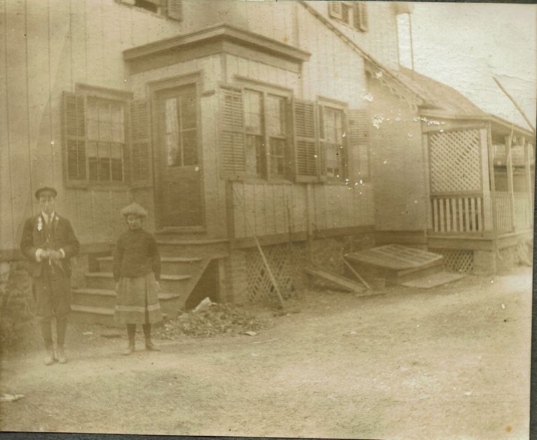          Marshall-Schmidt Photo Album: Boy and Girl Standing Outside a Wooden Building picture number 1
   