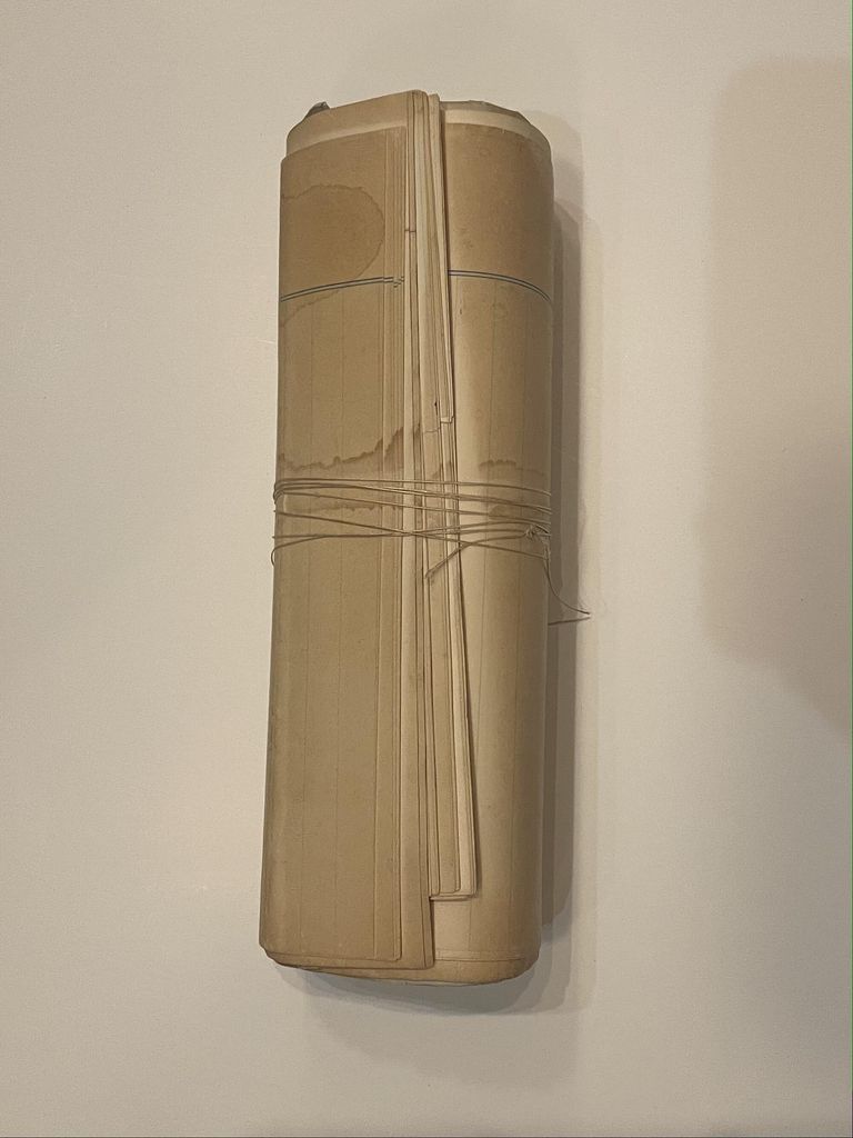          Notes folded and rolled up, bound by thread
   
