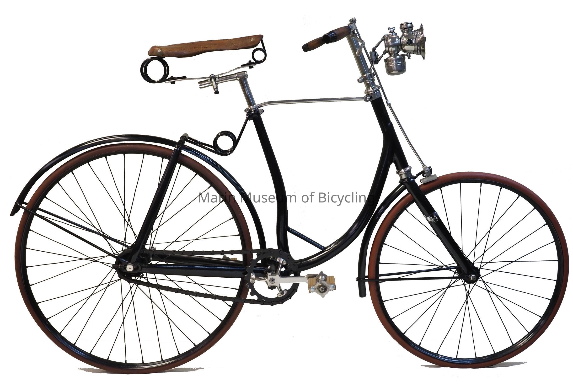 Front wheel diameter? Suspension travel?: With hard tires and the harsh ride of short spokes, the Rambler's rear swing arm and dual torsion springs smoothed the ride, as did the long saddle with springs at both ends. Unequal wheel size: G & J claimed that with 4/5ths of the weight on the rear wheel the front wheel could be lightened. The rear wheel is 30 inches, while the front is 26 inches. The 3/4" antimony-vulcanized Para rubber tires were moulded without a joint.