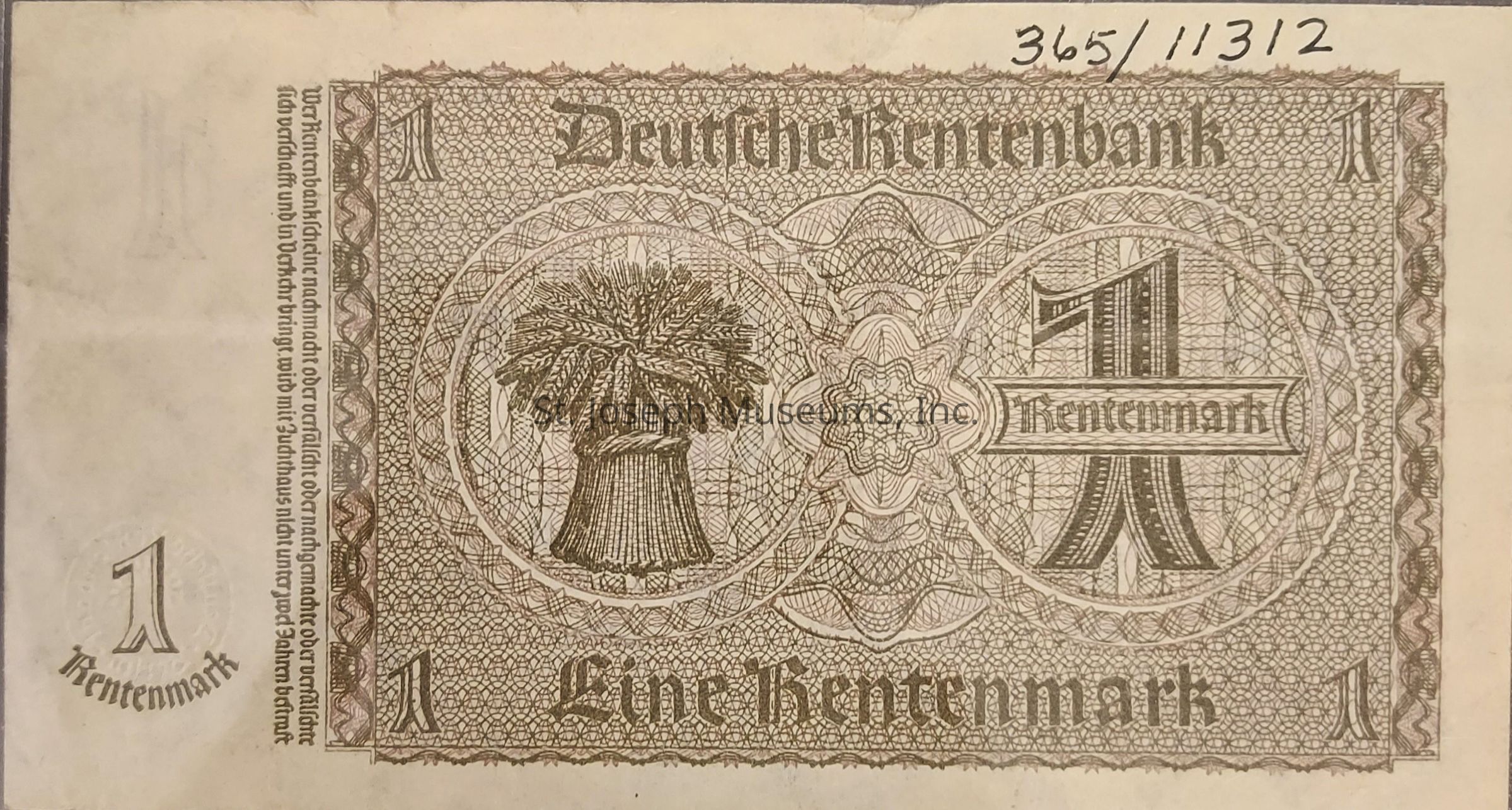 The image displays an intricately designed old German banknote, valued at 1 Rentenmark, issued by the Deutsche Rentenbank. The note predominantly features detailed geometric patterns and ornate calligraphic text, highlighting the denomination "1" prominently in the center, as well as on the corners. Within a circular emblem, there is an illustration of a bundle of wheat, symbolizing agriculture and prosperity. The words “Eine Rentenmark” are inscribed at the bottom, and an alphanumeric sequence, The overall color of the note is a brownish hue, typical of currency design from its era.