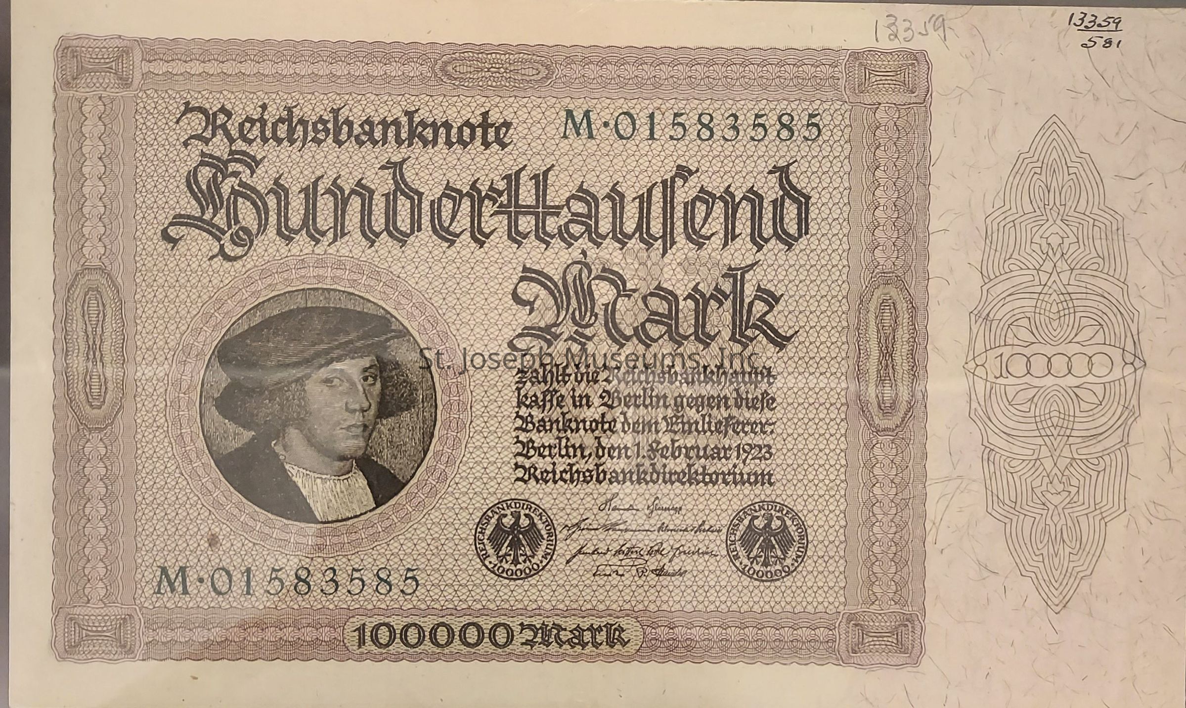 The image shows a historical banknote issued by the Reichsbank in Germany, denominated at one hundred thousand marks, with intricate patterns and a central portrait of a man wearing a hat, surrounded by ornate borders and gothic script. There is detailed text below the large denomination, and numerical identifiers and official seals are present, creating a visually complex and historically significant piece of currency from the year 1923. Handwritten numbers are visible in the upper margins, adding to the intricate design and unique historical context of the banknote, which reflects the hyperinflation period of the Weimar Republic.