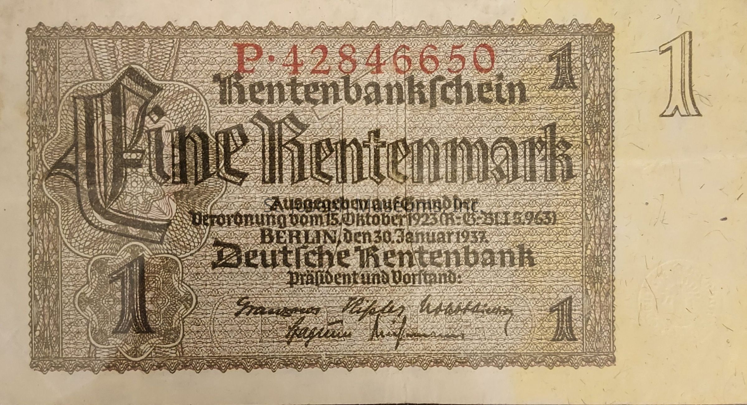 The image depicts a vintage German banknote, specifically a "Rentenbankschein" with a denomination of "Eine Rentenmark," featuring ornate and intricate designs in a combination of script and block text. The serial number "P. 42846650" is printed in red at the top, while the rest of the text is in black, providing details about its issuance in Berlin on January 30, 1937, as part of a financial reform from October 15, 1923. There are signatures at the bottom, and the border showcases an elaborate pattern. The number "1" is prominently displayed on each corner, reflecting its nominal value.