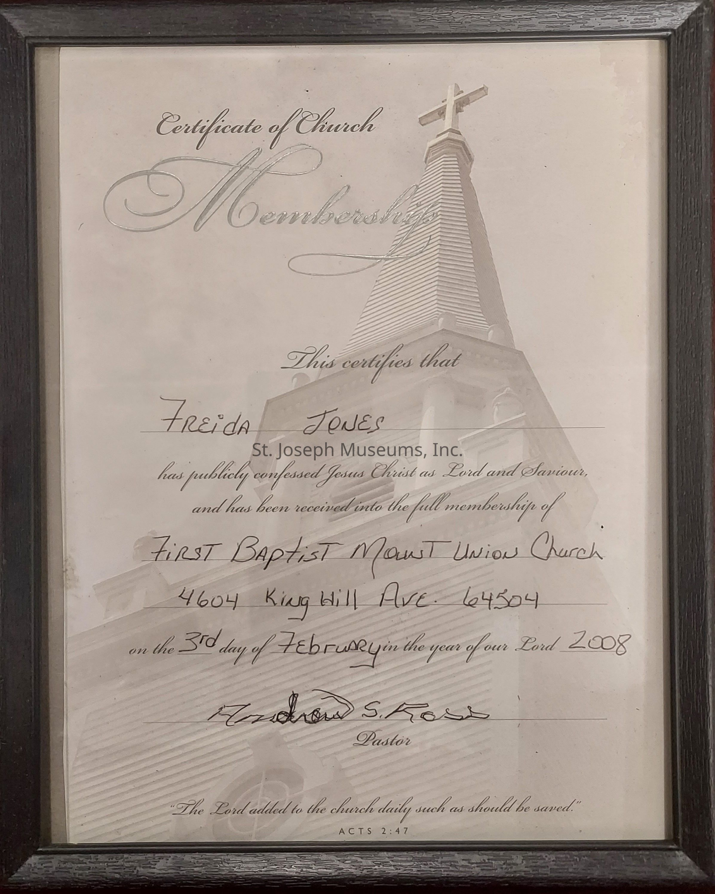 The image shows a framed Certificate of Church Membership, which features a watermark of a church steeple with a cross at the top. The certificate confirms that a person, named on the document, has publicly confessed Jesus Christ as Lord and Savior and has been received into the full membership of the First Baptist Mount Union Church, located at 4604 King Hill Ave, 64504. The membership was recognized on the 3rd day of February in the year 2008, and the certificate is signed by Andrew S. Fox, who is designated as the Pastor. At the bottom, there is a biblical reference from Acts 2:47, which emphasizes the addition of members to the church community.
