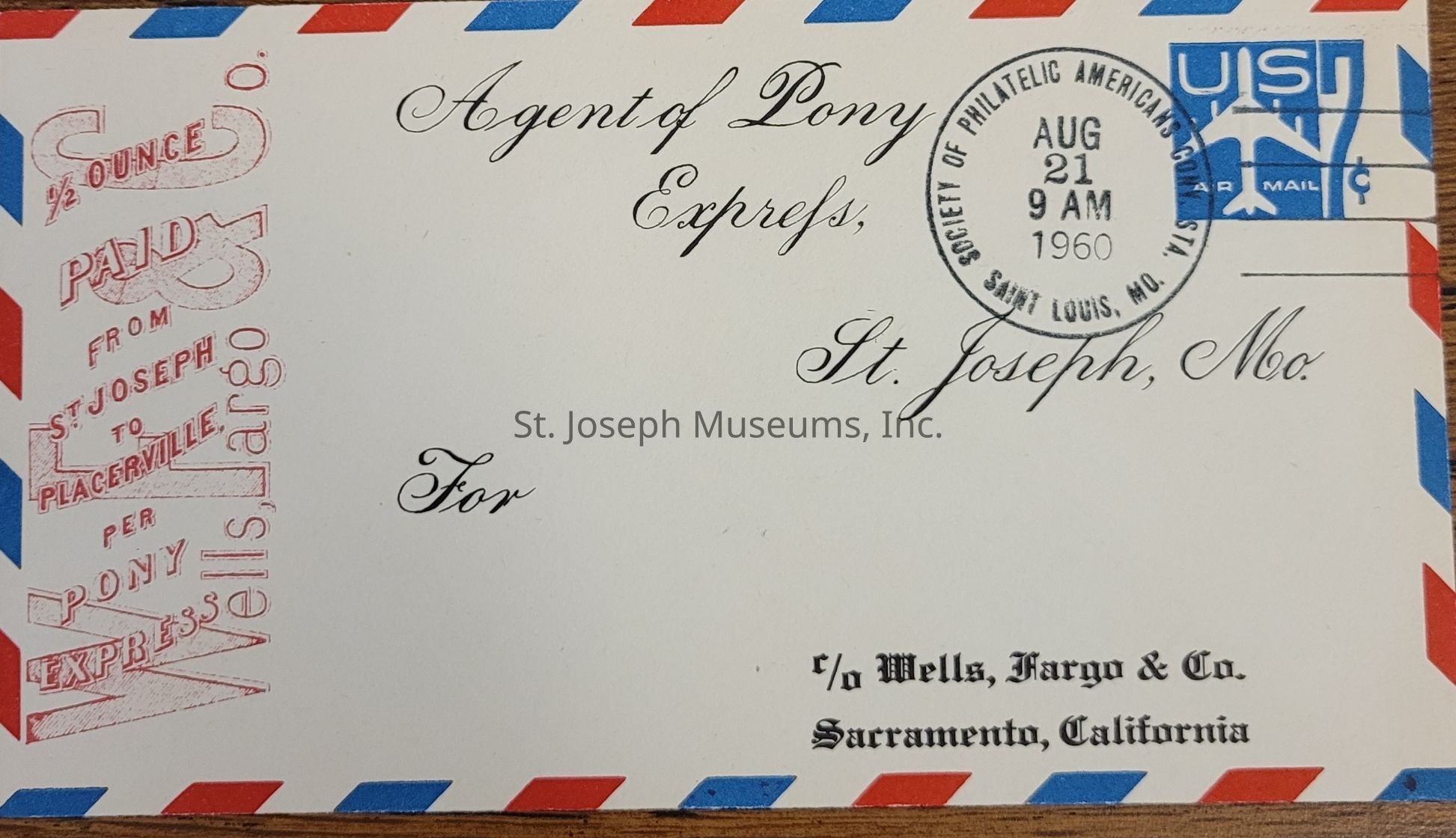 The image shows an envelope with a red and blue striped border, addressed to the Agent of Pony Express, St. Joseph, Missouri. There is a postmark indicating August 21, 1960, from the Society of Philatelic Americans Convention in St. Louis, Missouri. A blue airmail stamp is visible in the top right corner, and a red vertical stamp on the left reads “½ OUNCE PAID FROM ST. JOSEPH TO PLACERVILLE PER PONY EXPRESS WELLS FARGO & CO."