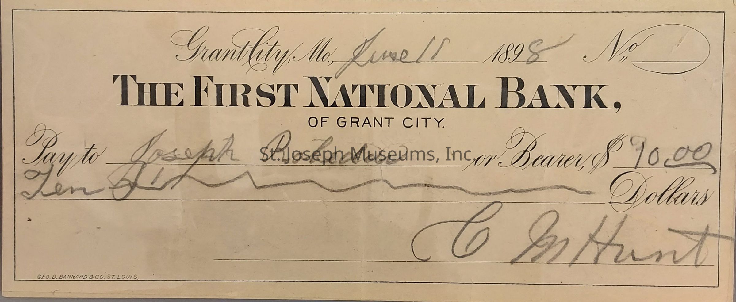 The image is of a historic check from "The First National Bank of Grant City," dated June 18, 1898. It is made payable to Joseph Rohdes or bearer, for the amount of $10.00. The check's information, including the date, recipient, amount, and the signature, is handwritten in elegant cursive. The check exhibits vintage typography indicative of the late 19th century. The issuing bank is identified at the top with bold lettering, and there is a note at the bottom left indicating it was printed by "Geo. D. Barnard & Co., St. Louis."