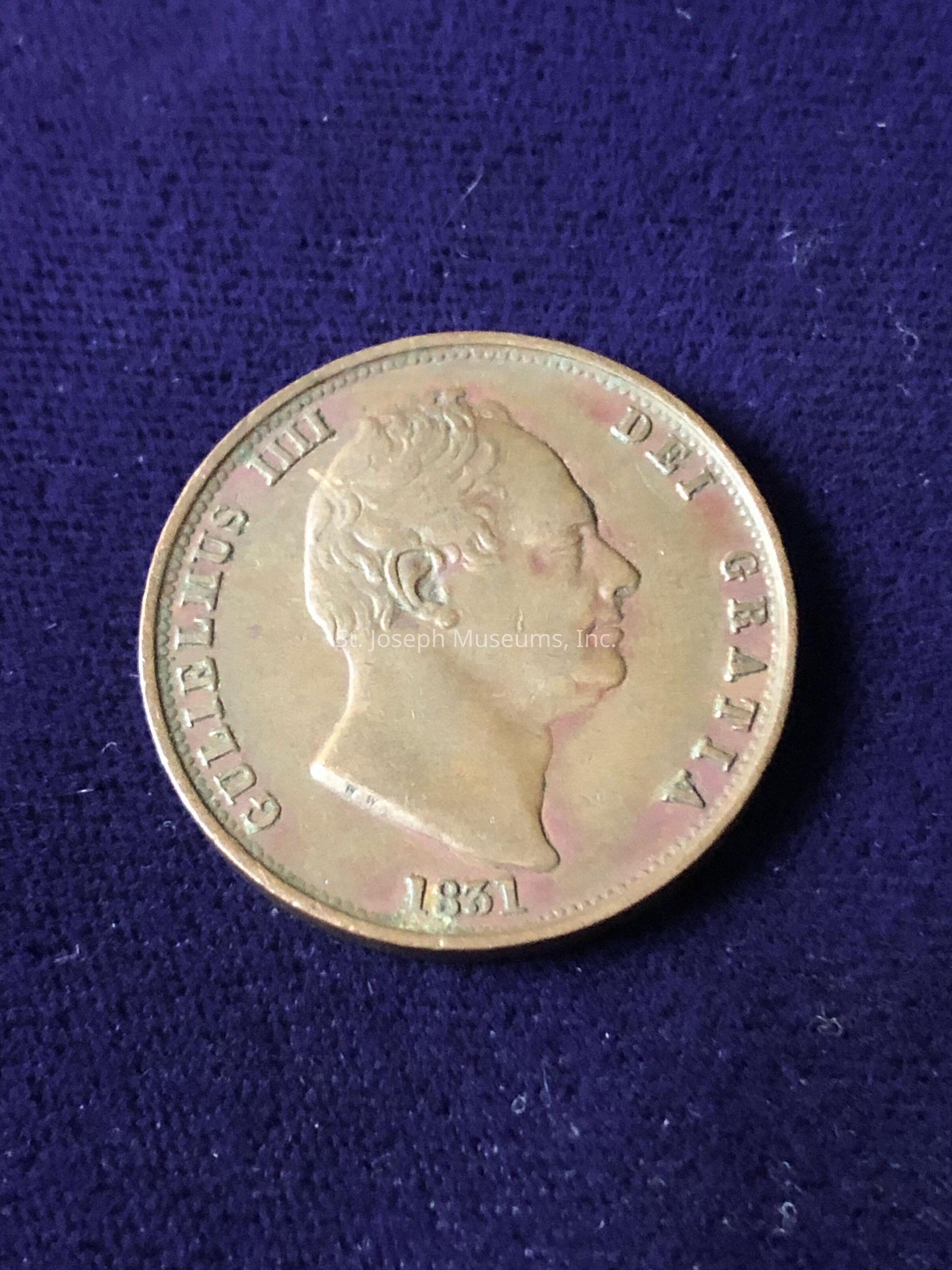 The coin features a profile portrait of a man facing right, surrounded by the inscription "GULIELMUS IIII DEI GRATIA." Below the portrait, the year "1831" is clearly visible, indicating when the coin was minted. The coin's metal surface has a patina, giving it a historic appearance, with subtle variations in hue adding depth to the intricate details of the design. The overall composition suggests an artifact of numismatic interest, possibly from the early 19th century, capturing a moment from the past with its regal depiction and classical engraving style.