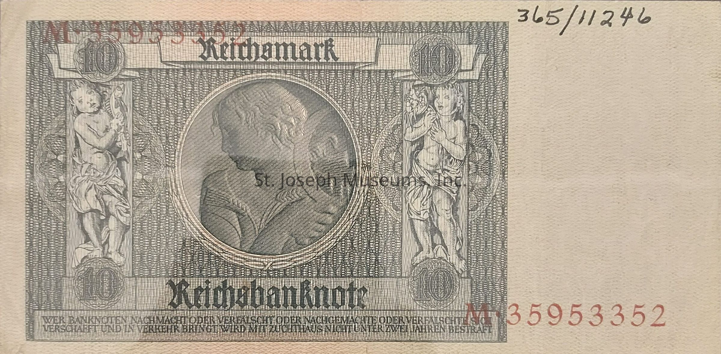 The image depicts a historical 10 Reichsmark banknote, characterized by intricate designs and engravings. The central area features a detailed profile portrait within a circular frame. Flanking the portrait are two ornate columns with cherubic figures. Ornate letters across the top spell "Reichsmark," accompanied by large numerical denominations in each corner. The serial number, in red, is prominently displayed along the bottom. Text in a Gothic typeface reads "Reichsbanknote," and additional small text is present near the bottom edge, likely containing legal or identification information. The design is monochromatic, primarily in shades of gray, showcasing fine artistry befitting its era.