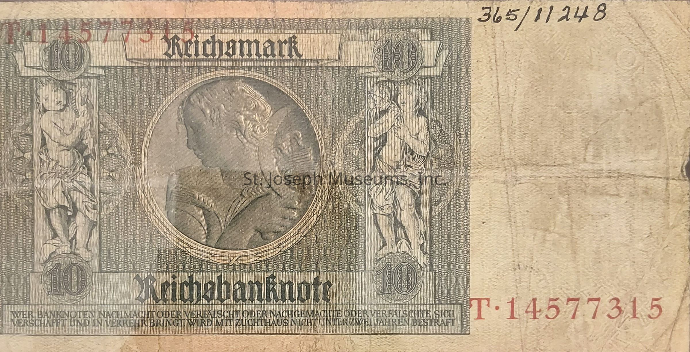 The image shows a historical 10 Reichsmark banknote with intricate designs, featuring the word "Reichsbanknote" prominently across the lower section of the note. In the center is a detailed circular engraving of a figure in profile, surrounded by ornate patterns. To the left and right of this figure are two vertical allegorical figures, each holding symbols, positioned above the denomination "10" in a decorative circle. The note includes serial numbers printed in red in the upper left corner and bottom right corner. The texture appears aged, with visible folds and creases adding character to the note. The text at the bottom warns against counterfeiting or falsification, highlighting the serious legal consequences.