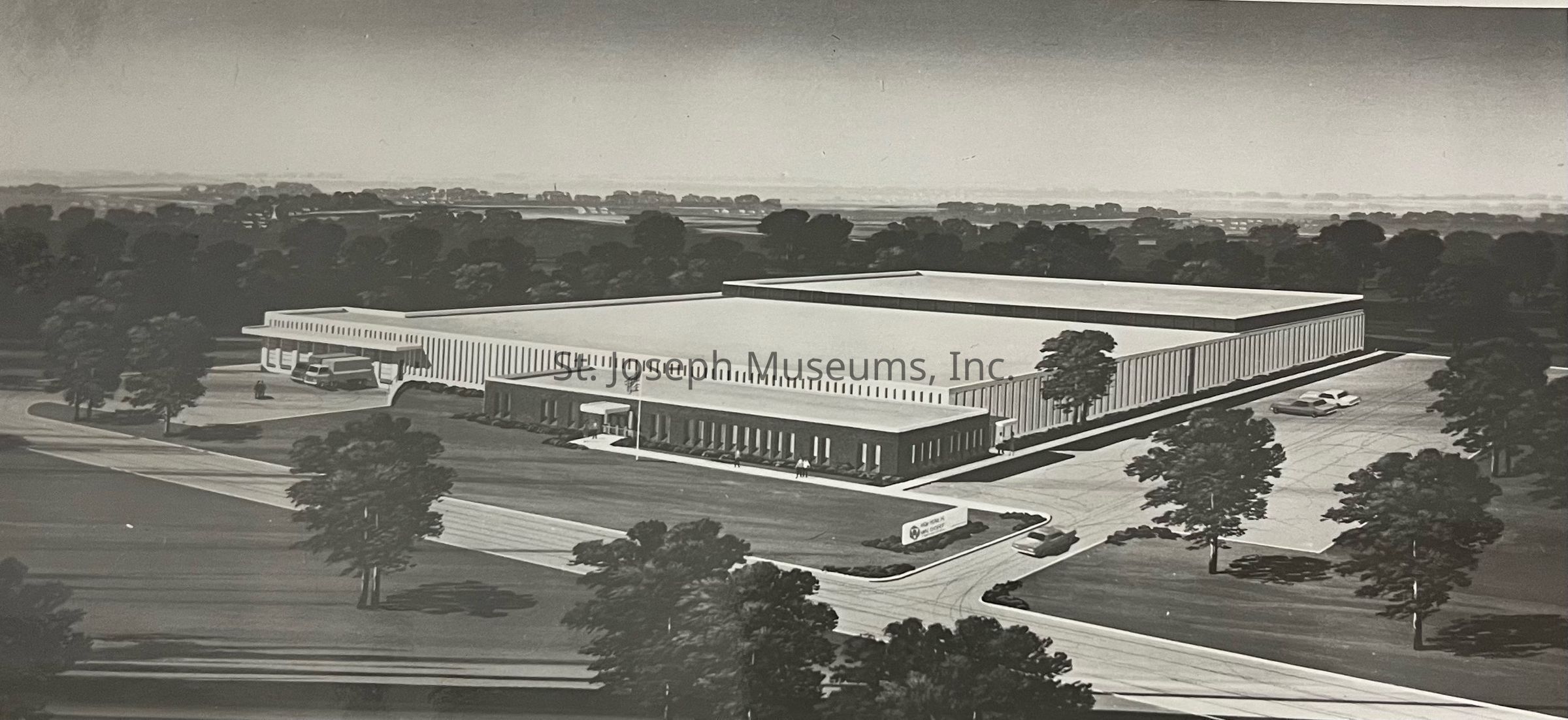 Black-and-white image depicting an architectural drawing of the Hoerner Waldorf Company building at 2315 Lower Lake Road in St. Joseph, Missouri, featuring a modernist design with a large, rectangular structure surrounded by trees, parking areas, and landscaped lawns, showcasing its integration into a suburban environment.