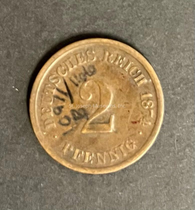 The image displays an old coin from the German Empire, dated 1875, with the denomination "2 Pfennig" prominently embossed in the center. The phrase "DEUTSCHES REICH" encircles the upper half of the coin, indicating its origin from the German Empire. The coin's surface shows signs of aging and wear, with visible scratches and a tarnished patina that emphasizes its historical nature.