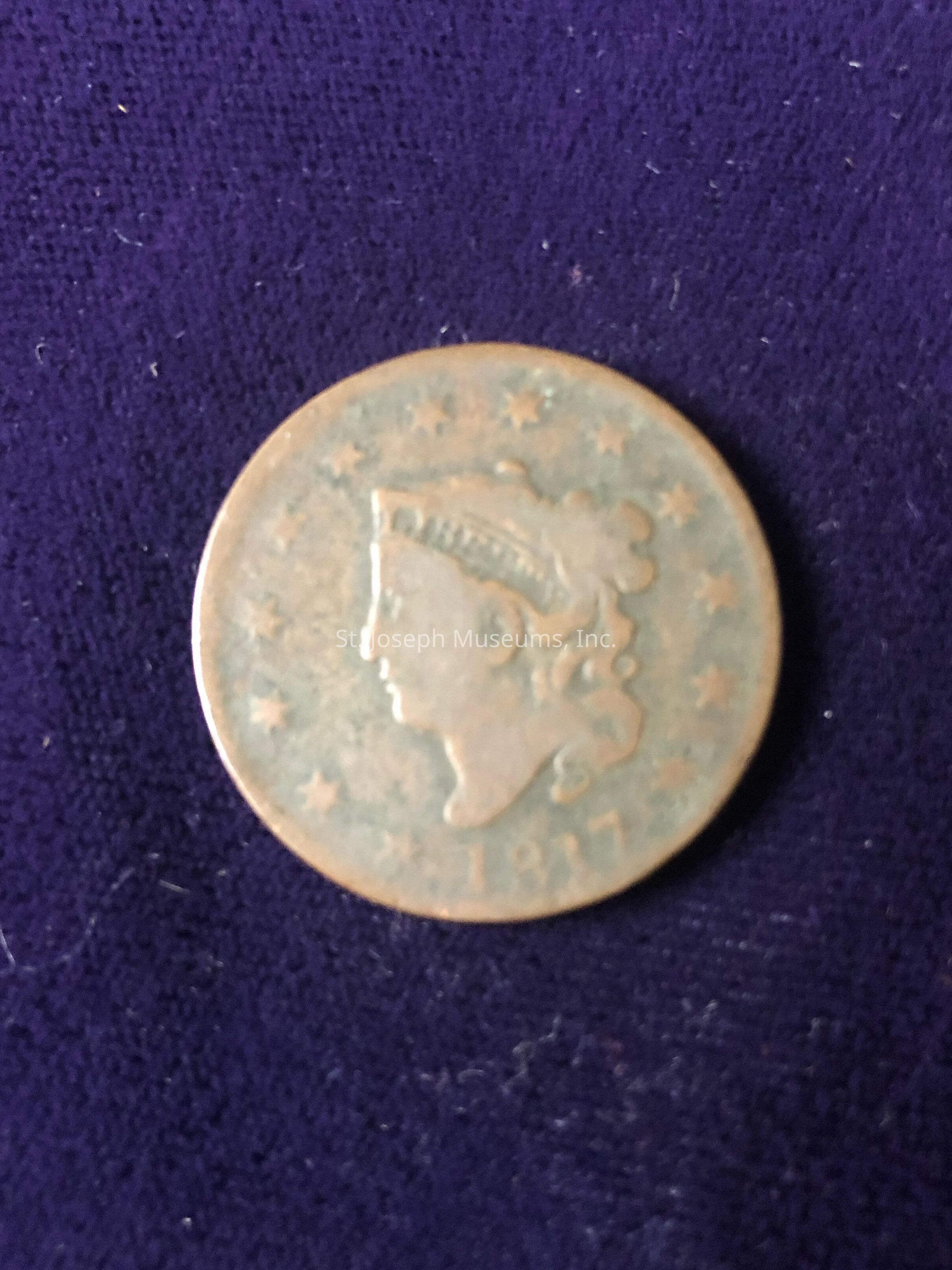 The coin displays the classic Liberty Head design, with Liberty facing left and adorned with a headband inscribed with "LIBERTY." Around Liberty's head, there are thirteen stars signifying the original thirteen colonies. The coin's surface appears worn, suggesting its age and historical significance, yet the details of the profile, stars, and the date at the bottom remain visible, though they show signs of wear. The overall tone of the coin ranges between copper and brown, indicative of its composition and age-related patina.