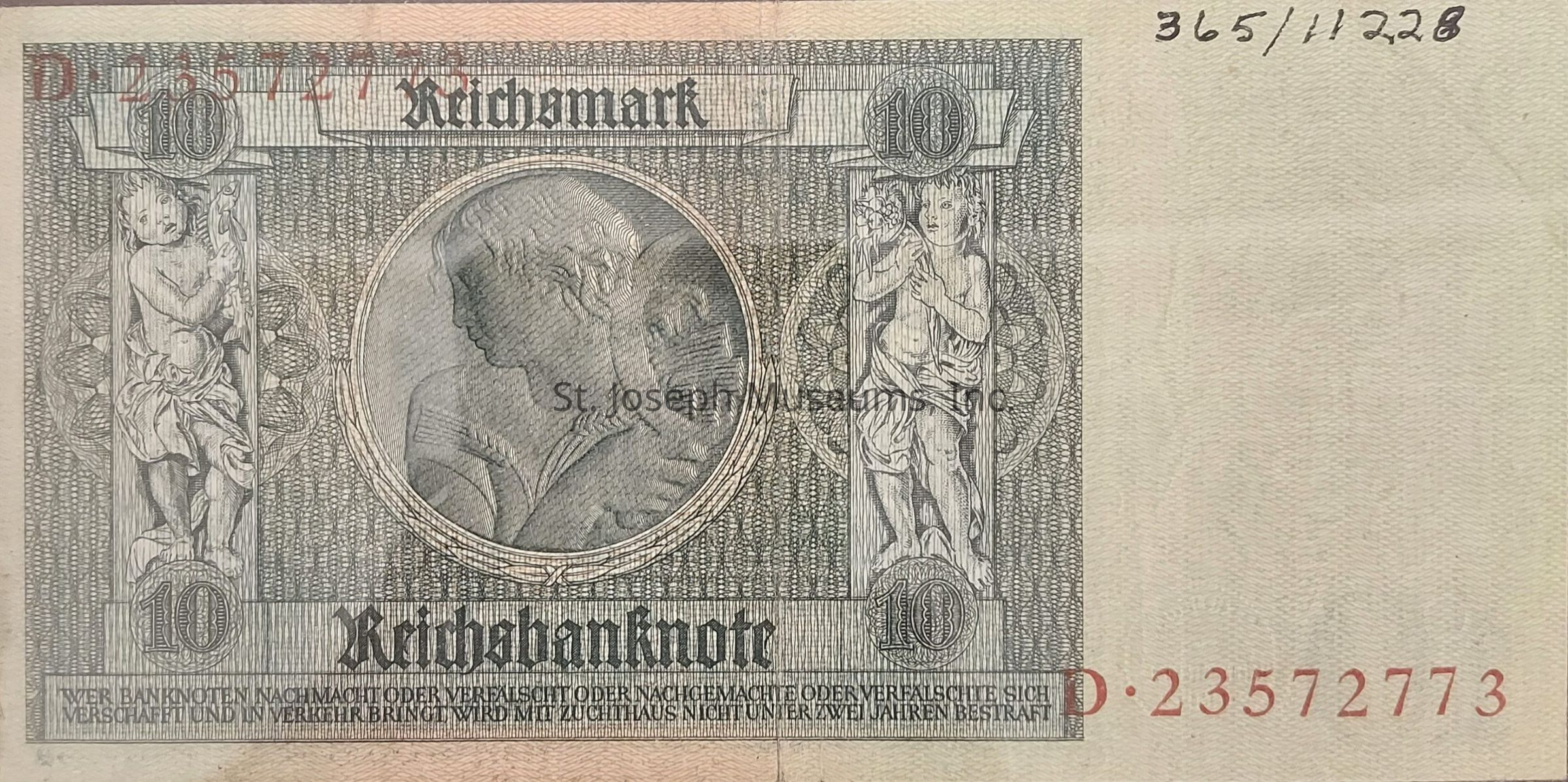 The image depicts a historical German banknote with intricate designs and artistic engravings. In the center, there is a portrait of a man framed within a circle, surrounded by detailed patterns. On either side, two decorative columns are adorned with figures holding various objects. The top portion displays "Reichsmark" prominently, indicating the currency, with the denomination "10" appearing in both corners. Below, the word "Reichsbanknote" is inscribed, and a series of numbers are printed in red, likely serving as a serial number. The design reflects a blend of artistry and historical significance, showcasing elements typical of traditional banknote aesthetics.