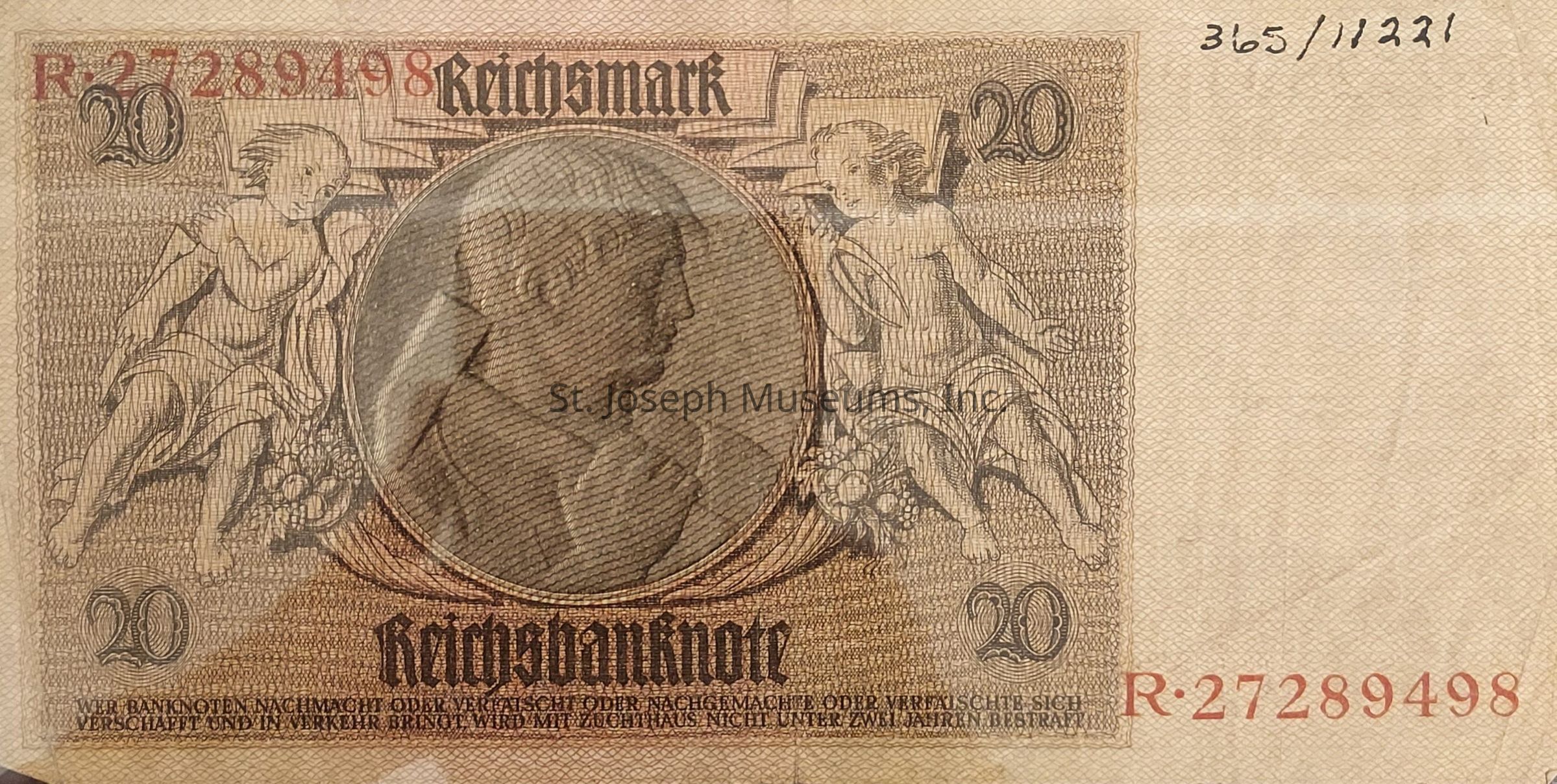 The image depicts an old German banknote, specifically a 20 Reichsmark note. The design features an intricate pattern with two cherubic figures on either side, each holding a collection of fruits or produce, representing abundance or prosperity. In the center is an ornate oval frame enclosing a profile portrait, likely of a historical or allegorical figure, rendered in a classic engraving style. The denomination "20" is prominently displayed in the upper left and right corners. The text, "Reichsbanknote," is printed in a Gothic script below the portrait, along with a statement in German about the legal implications of counterfeiting. A serial number "R-27289498" is printed in red on the left side.