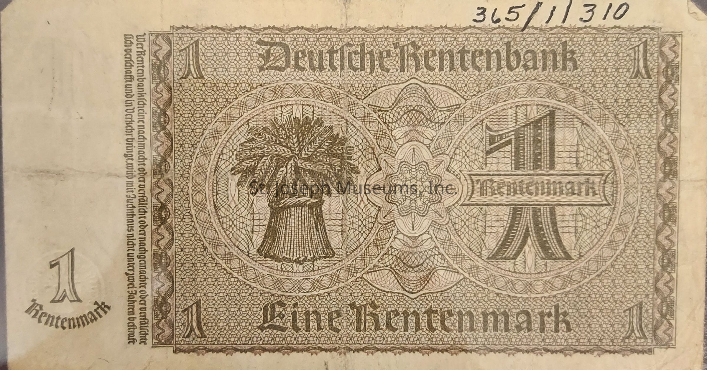 The image depicts an old German banknote with the denomination of one Rentenmark. The note's design is intricate, featuring detailed patterns and a central illustration of a sheaf of wheat, symbolizing agriculture and prosperity. The words “Deutsche Rentenbank” are printed prominently at the top, while "Eine Rentenmark" appears at the bottom. The number “1” is printed in all four corners, The overall color scheme is monochromatic, giving it a vintage appearance, and the paper shows signs of aging, which adds historical value.