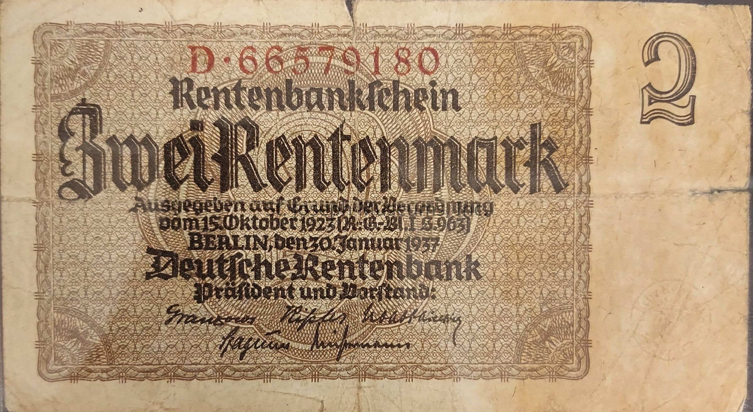 The image depicts a vintage German banknote known as the "Zwei Rentenmark," which translates to "two rentenmarks." This currency, issued by the Deutsche Rentenbank, features intricate patterns and designs, including decorative borders and ornate text. The note prominently displays the denomination "2" on the upper right corner, with the serial number "D–66579180" printed in red above the patterned area. The text indicates that it was issued in Berlin, following the October 15, 1923 ordinance, and features the date January 30, 1937. Signatures of bank officials appear at the bottom, highlighting its authenticity and official status. The overall appearance suggests historical significance, as it represents a period of economic transition in Germany.