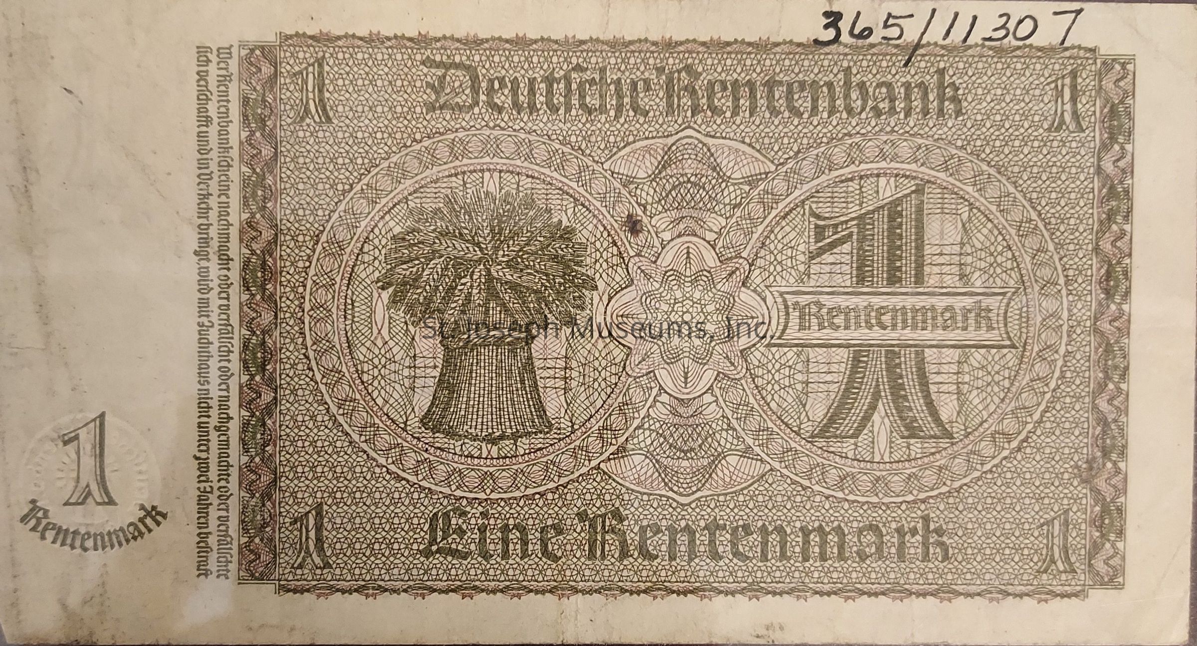 The image shows a banknote from the Deutsche Rentenbank with an ornate design featuring intricate patterns and script. The denomination "1 Rentenmark" is prominently displayed in the center, surrounded by decorative circular elements. On the left side, there is an illustration of a sheaf of wheat, symbolizing agriculture. The text is in German, with "Deutsche Rentenbank" at the top and "Eine Rentenmark" at the bottom. The note has an elaborate border design, enhancing its visual complexity. In the top right corner.