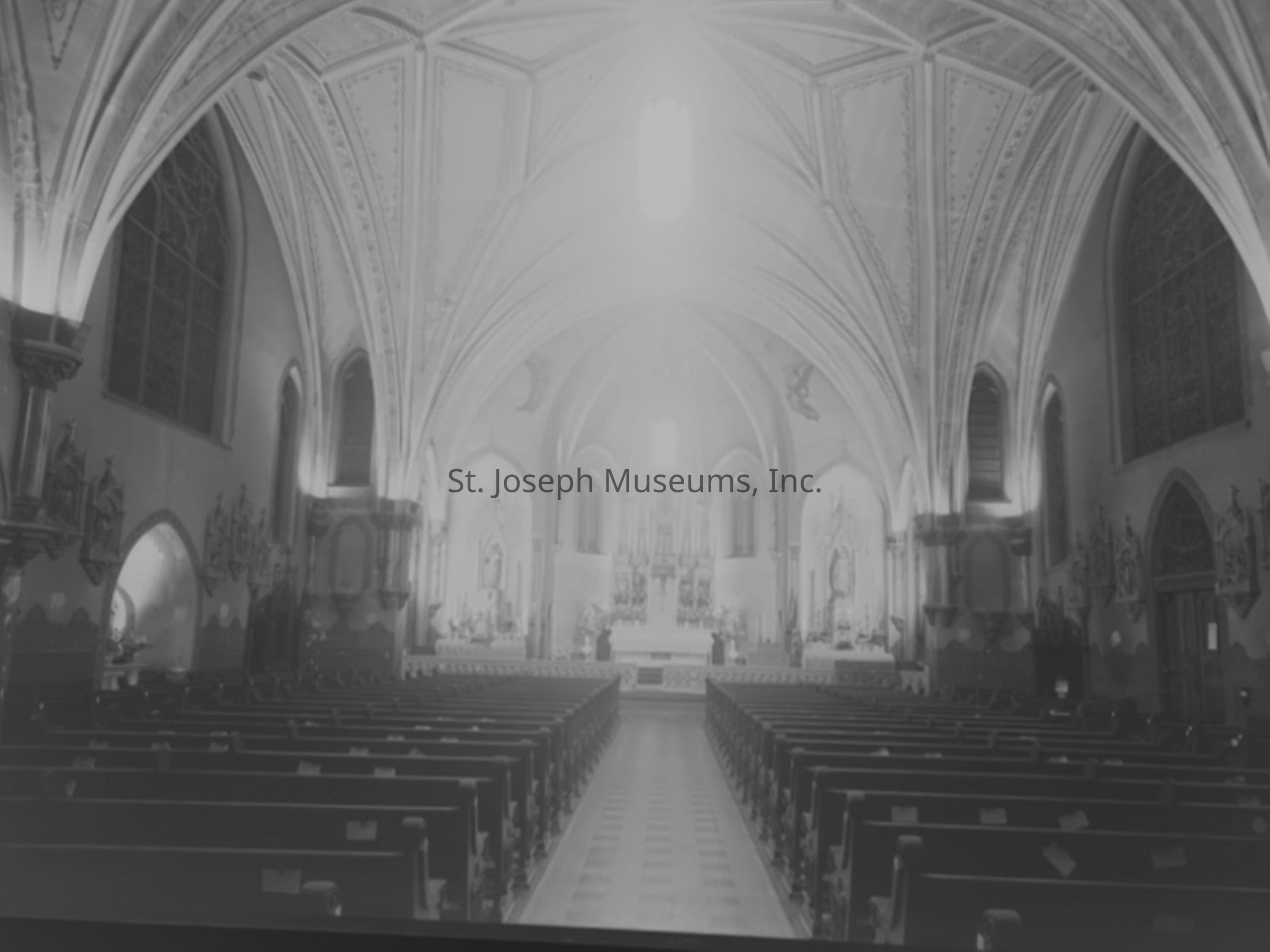 A black-and-white photograph of the interior of the Immaculate Conception Church, now known as Queen of the Apostles, located at 501 S 10th in St. Joseph, Missouri, showcases an impressive architectural design with intricate vaulted ceilings and high arches. The expansive space features rows of wooden pews leading to an ornate altar, illuminated softly by ambient light filtering through stained glass windows. The elegant Gothic revival style is complemented by detailed religious artwork adorning the walls.