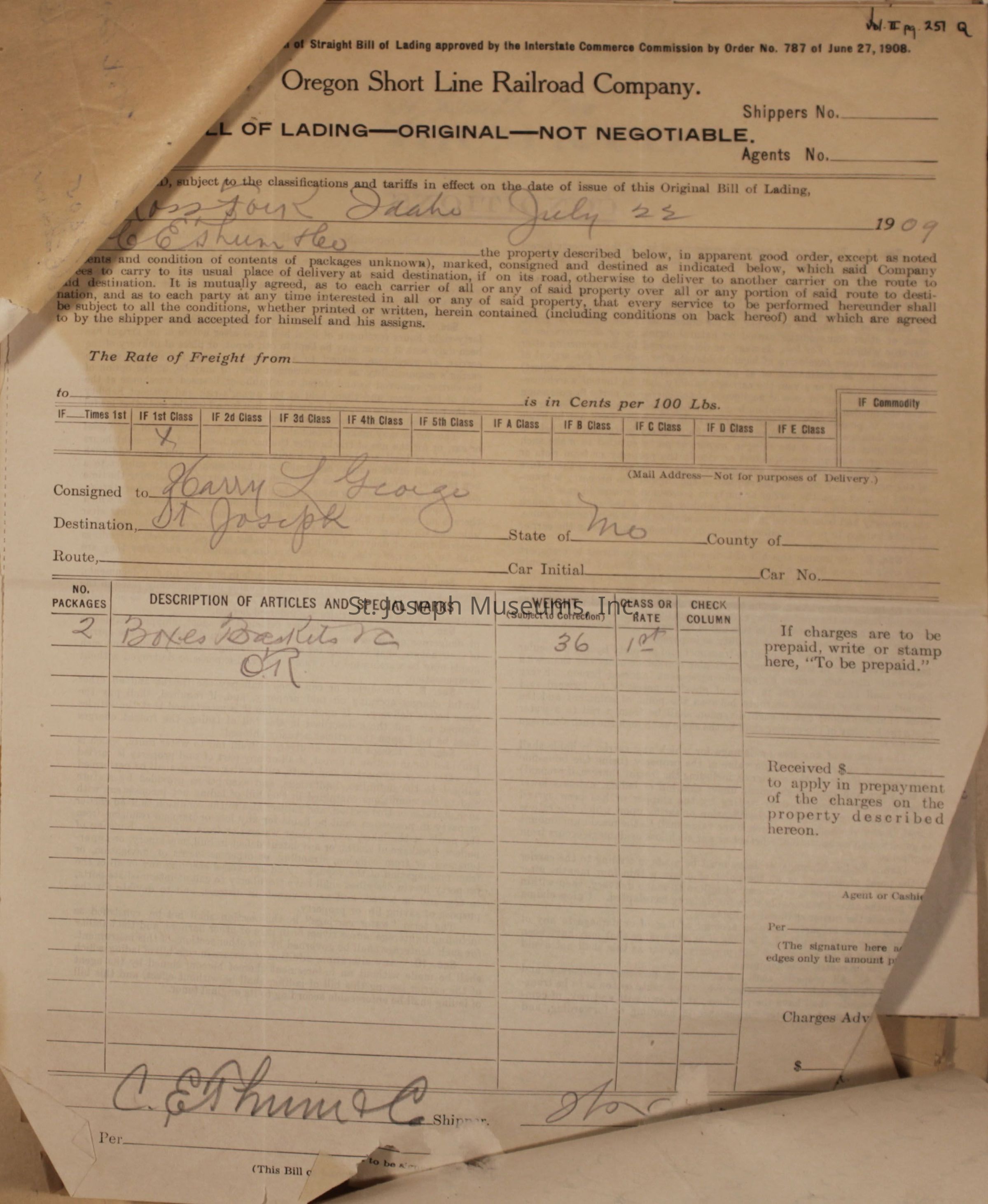 This image is an old bill of lading from the Oregon Short Line Railroad Company, dated July 22, 1909, shipped from Idaho and intended for delivery to St. Joseph, Missouri, to Harry L. George. The document shows a shipment of two boxes weighing 36 pounds classified as "1st class" and includes handwritten details about the freight.