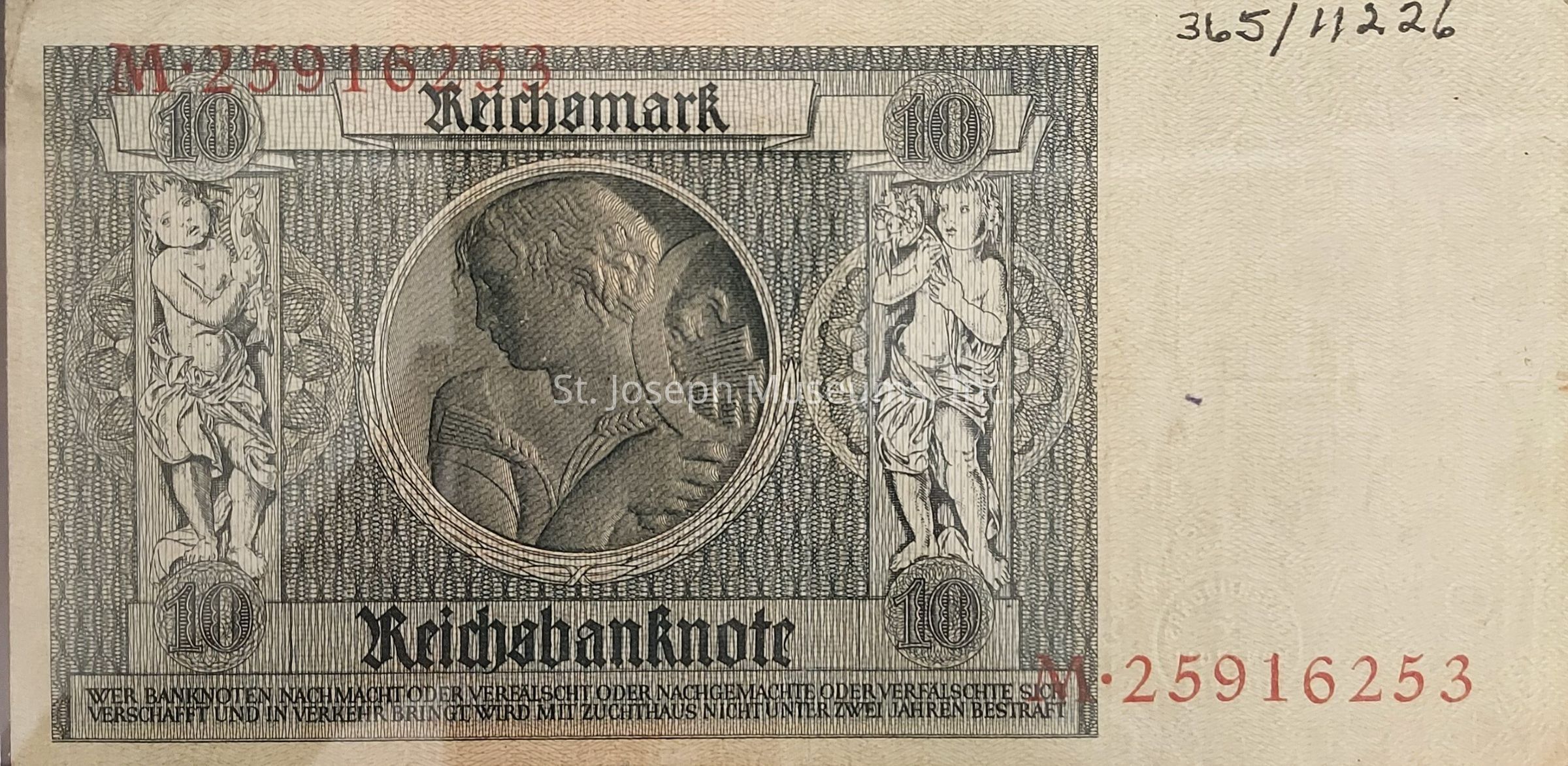 The image depicts a historical 10 Reichsmark banknote, featuring intricate black and white engravings. At the center is a profile portrait of a woman adorned with an elegant headdress, surrounded by ornamental design elements and a circular frame. Flanking the portrait are two cherubic figures, one on each side, standing within detailed colonnade-like structures, each holding an object. The denomination "10" is prominently displayed in two places, one above each cherub, within decorative frames. The words "Reichsbanknote" are inscribed boldly beneath the central portrait, signifying the note's authenticity and value. Red serial numbers, "M 25916253," are visibly printed on the bottom and upper parts, marking the specific issue of the note. Tiny detailed patterns fill the background, showcasing the note's complexity. Gothic-style lettering at the bottom provides legal text, emphasizing the consequences of counterfeiting. The overall design reflects the period's artistic and cultural tendencies, blending classical