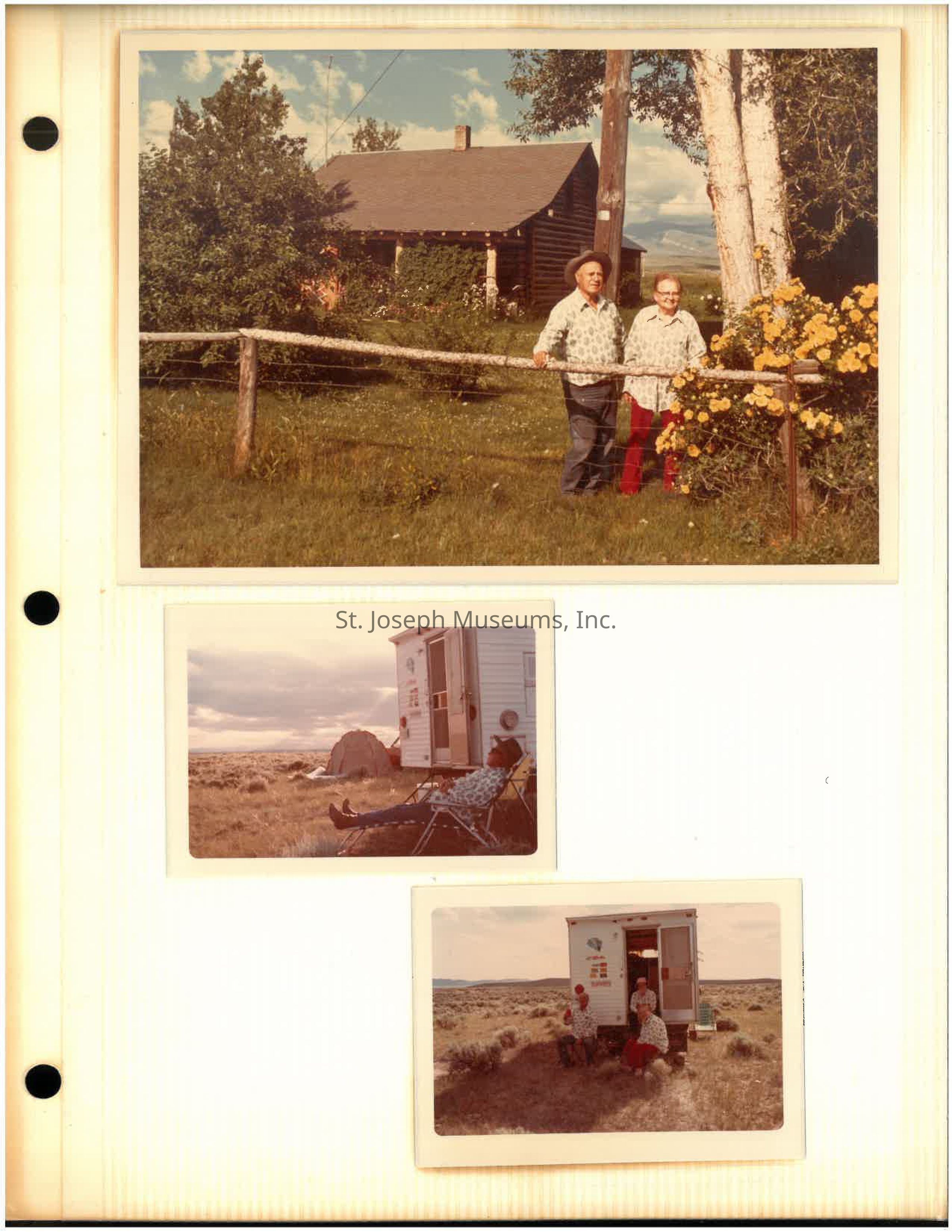 Click for PDF: The image is a vintage photo album page featuring three pictures. The top photograph shows an elderly couple standing in front of a rustic wooden house with a sloping roof, surrounded by lush greenery and vibrant yellow flowers, under a clear blue sky. The middle image depicts a person relaxing on a lawn chair, positioned next to a small camper trailer, set against a vast, open landscape marked by sparse vegetation and distant mountains. In the bottom photo, two individuals are seated at the entrance of the same camper