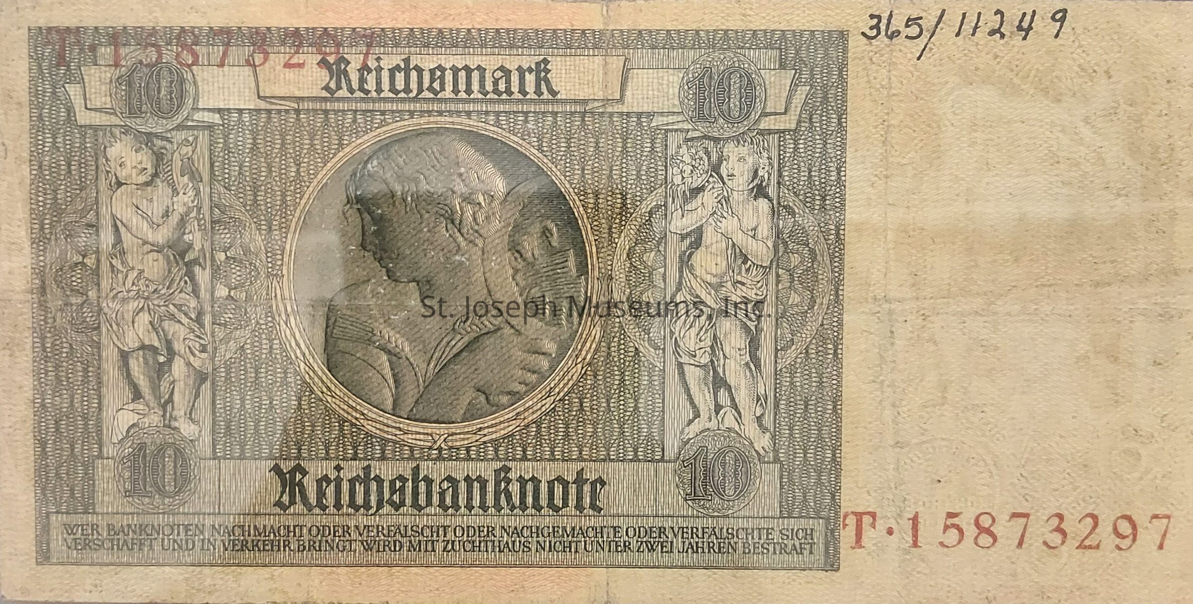 The image displays an old banknote with the denomination of "10 Reichsmark" prominently printed. It features intricate artwork, including two detailed figures on either side of the note and a circular portrait in the center. The background is filled with elaborate patterns that enhance the complexity of the design. Along the top and bottom, the name "Reichsbanknote" is inscribed in prominent Gothic script. In the top corners, the numbers "10" are enclosed within decorative circles. The note has identification numbers printed in black on the upper right, while another series of numbers appears in red at the bottom. The lower portion includes a warning text against counterfeiting. The overall aesthetic is historic, reflecting the design style and currency system of a past era. The wear and discoloration suggest the age and usage of the banknote.