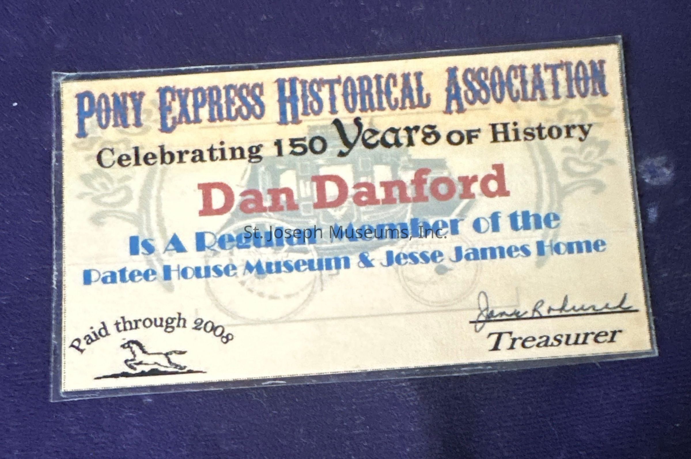 The image depicts a membership card for the Pony Express Historical Association, celebrating 150 years of history. The card is issued to Dan Danford, acknowledging him as a regular member of the Patee House Museum & Jesse James Home. It is valid through 2008, as noted in the lower left corner, featuring a small illustration of a horse. The card is signed by the treasurer, whose signature appears at the bottom right.