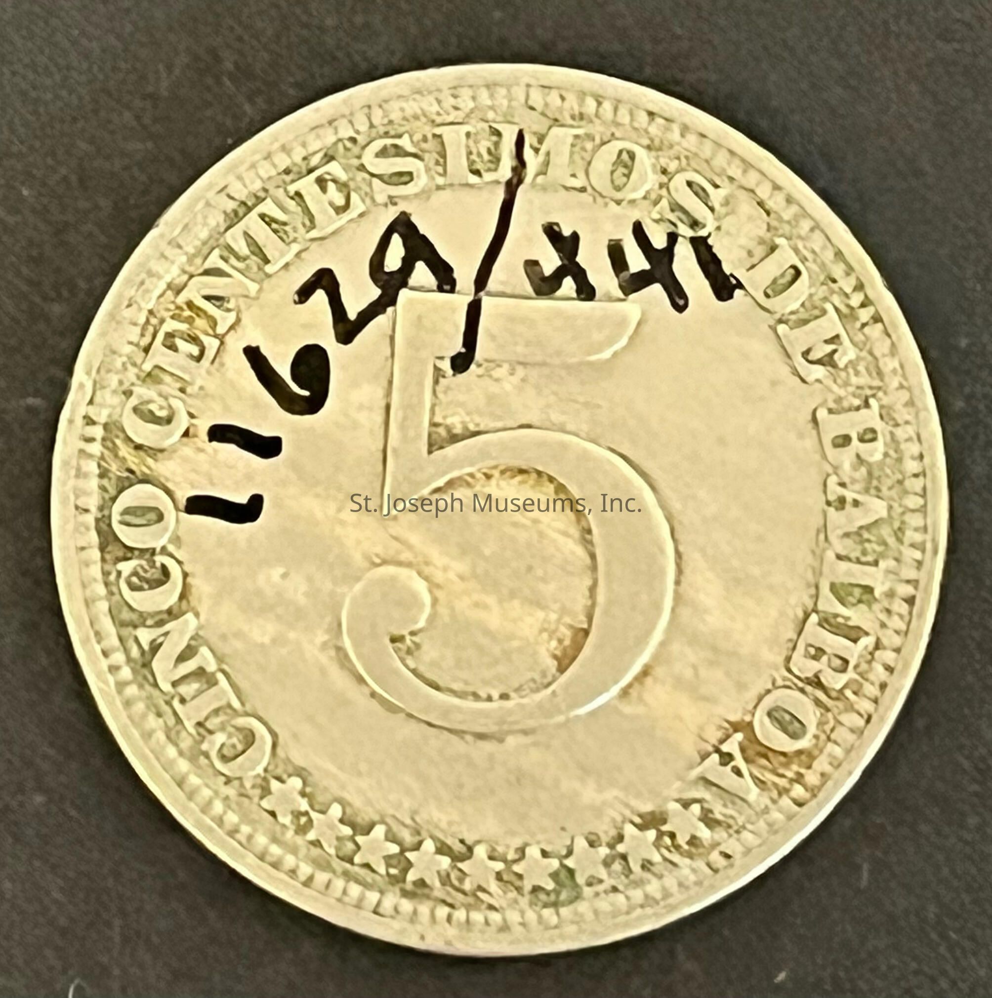 The image shows a coin featuring the denomination "5" prominently in the center. Encircling the number, the words "CINCO CENTÉSIMOS DE BALBOA" are inscribed along the rim. The surface has a metallic texture with a slightly worn appearance, suggesting it has been in circulation. Around the edge, a series of stars are embossed, adding to the design. Notably, the coin has some black markings—specifically the numbers "1162" and "344" hand-written or stamped at the top, which stand out against the background, giving it a unique modified appearance. The overall contrast and clarity indicate it's displayed against a plain, dark backdrop that highlights the coin's details.