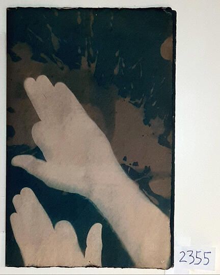 Handmade Dog Cyanotype No. 17 of 32: Norman Durkee, a Seattle composer, was a friend of mine and he sent me a tape of works made on his new Buchla synthesizer. One was titled, "Handmade Dog," a silly, rambling ditty with his synthesized "Woof woof" interspersed. My thought was to collaborate with Norman with my own handmade dogs. I had been doing such hand-shadow prints for some time. The technique, cyanotype, is sometimes called "sun printmaking" because sunlight is ideal, especially in months when the sun is high and rich in UV. The method requires coating paper with chemicals, letting it dry in a dark place, and then - in the sun as I did in this series - laying the paper out flat and putting like one's hand on it. Where the sun strikes the chemical, a reaction occurs and after some seconds or a minute, the paper is shielded until it can be washed. In cold, running water, the unexposed chemicals dissolve and wash away. Where the sun struck, the chemicals became insoluble and turn blue. Invented at the time many photo processes were (the mid-19th Century), it never achieved commercial value except in making blueprints and fine art photographs. To make the series of 32 prints I made a cyanotype or two a day in the summer of 1982, climbing to the rooftop hatch to the top of the Journal of Commerce Building in Seattle, which was home to the Triangle Studios for me from 1977-1983. See my memoir, "Dumb Hope: My curious life - 1981-1990."