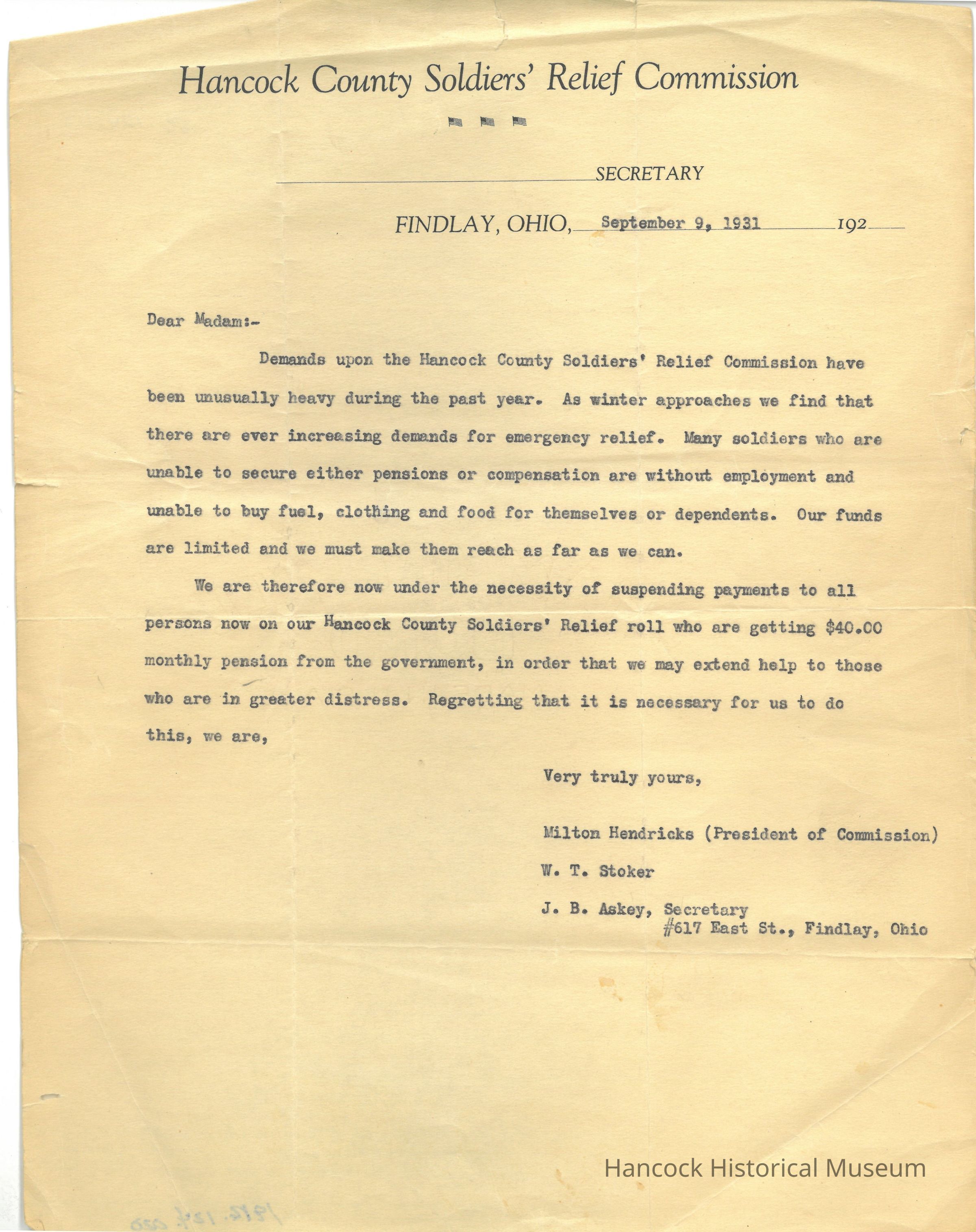 The image displays a typewritten letter from the Hancock County Soldiers' Relief Commission, dated September 9, 1931, from Findlay, Ohio. The letter is addressed "Dear Madam" and discusses the unusually heavy demands on the commission's resources over the past year. It emphasizes the increasing need for emergency relief as winter approaches, highlighting that many soldiers without pensions or compensation are unemployed and unable to afford basic necessities such as fuel, clothing, and food. Due to limited funds, the commission is suspending payments to those receiving a $40 monthly pension from the government, in order to assist those in greater distress. The letter is signed by Milton Hendricks, President of the Commission, along with W. T. Stoker and J. B. Askey, the Secretary, whose address is listed as 617 East St., Findlay, Ohio.