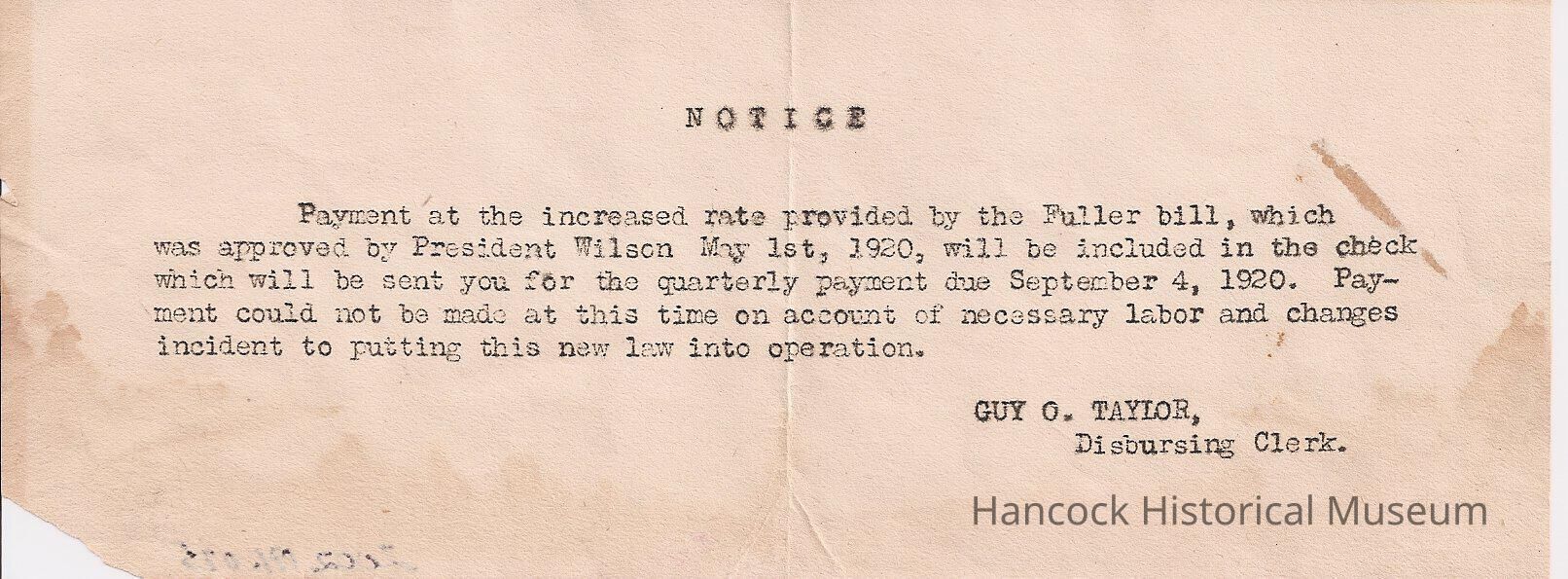 The image depicts a typewritten notice informing recipients about a payment adjustment due to the Fuller bill, approved by President Wilson on May 1st, 1920, stating that the increase will be included in the check for the quarterly payment on September 4, 1920; however, the payment could not be issued immediately due to labor requirements and changes associated with implementing the new law, with the notice signed by Guy O. Taylor, the Disbursing Clerk, and the paper shows signs of wear with small stains and creases along the edges, enhancing its historical feel.