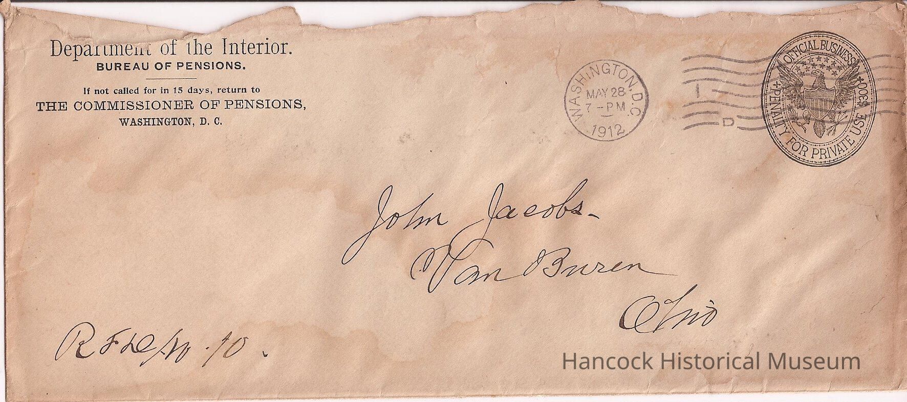 The image shows an old, worn envelope from the Department of the Interior, Bureau of Pensions, with instructions to return it to the Commissioner of Pensions in Washington, D.C., if not claimed within 15 days. The envelope is addressed to John Jacobs with an illegible city possibly named Van Buren, in Ohio. The postmark is stamped from Washington, D.C., dated May 28, 1912, at 7 PM. The envelope also features a circular stamp indicating "Official Business" and "Penalty for Private Use," embellished with an eagle emblem. The envelope appears aged, with noticeable wear and discoloration, indicating its historical nature.