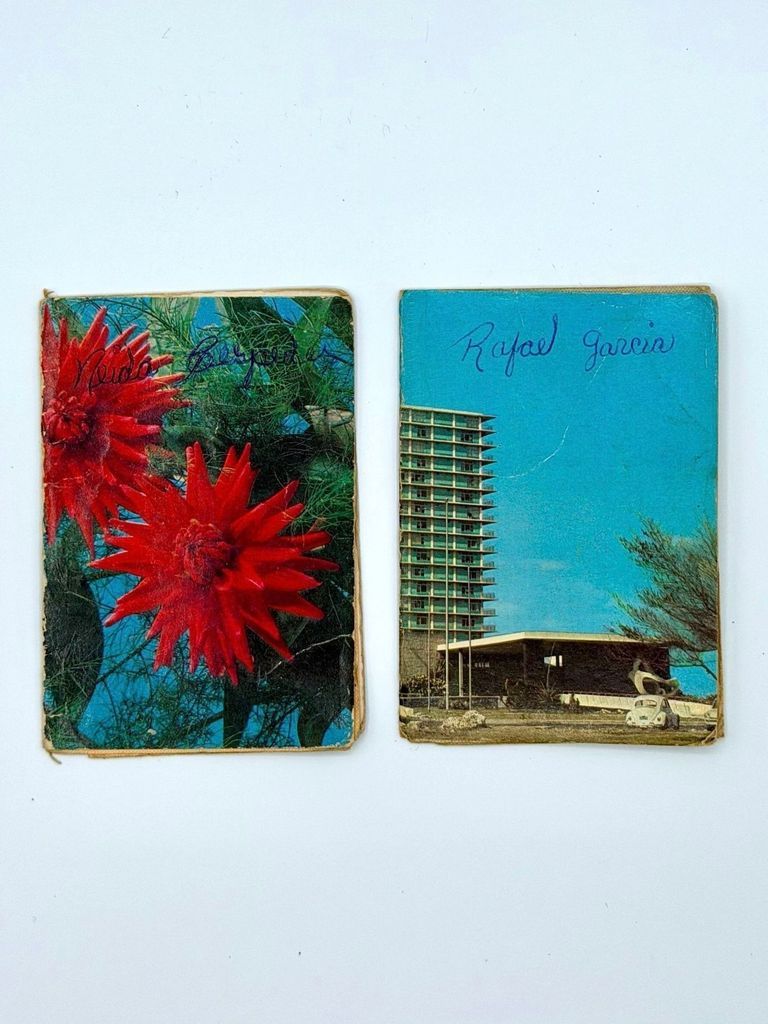 Libreta de Productos Industriales (Cuban industrial-goods / clothing ration book), 1989 — two examples with repurposed postcard covers
